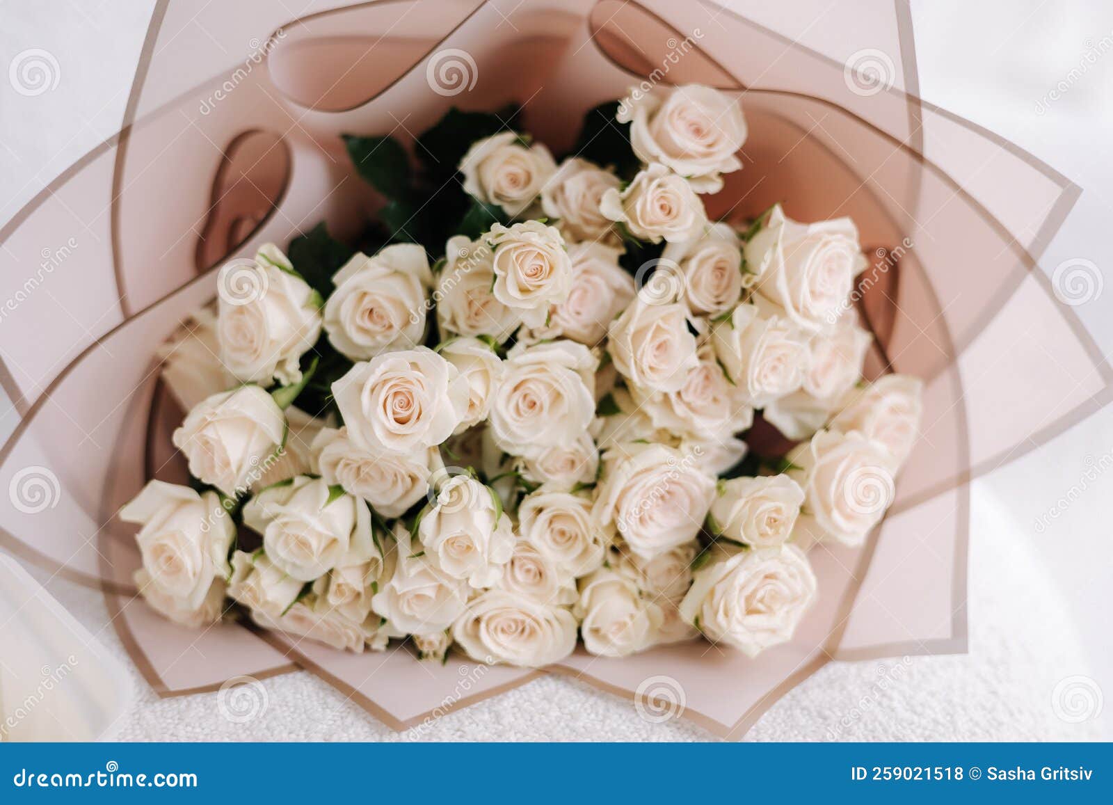 bouquet of white flowers in gift packaging. reses