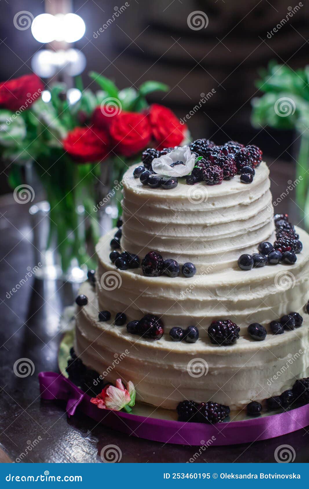Bouquets in Vases and a Wedding Cake Decorated with Berries Stock Image