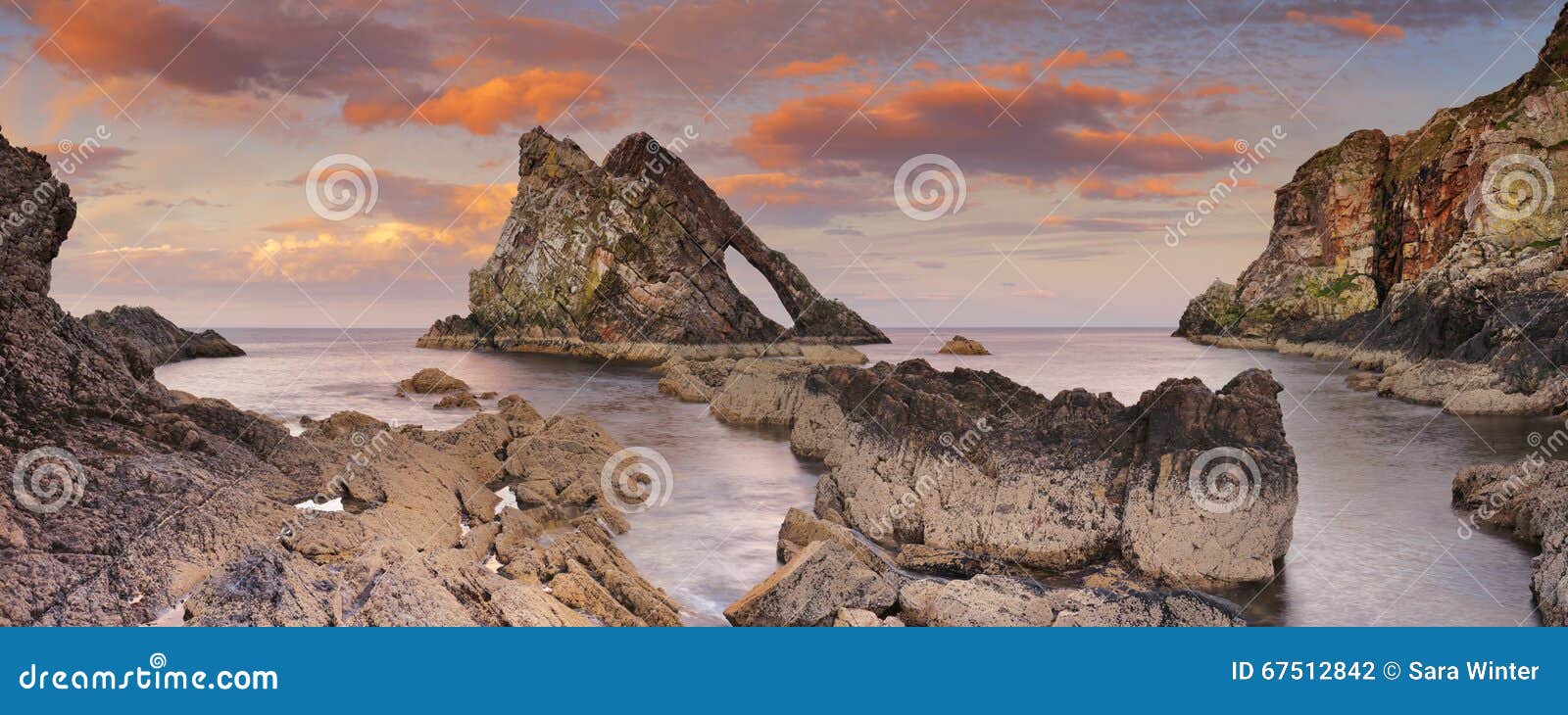 bow fiddle rock on the moray coast, scotland at sunset
