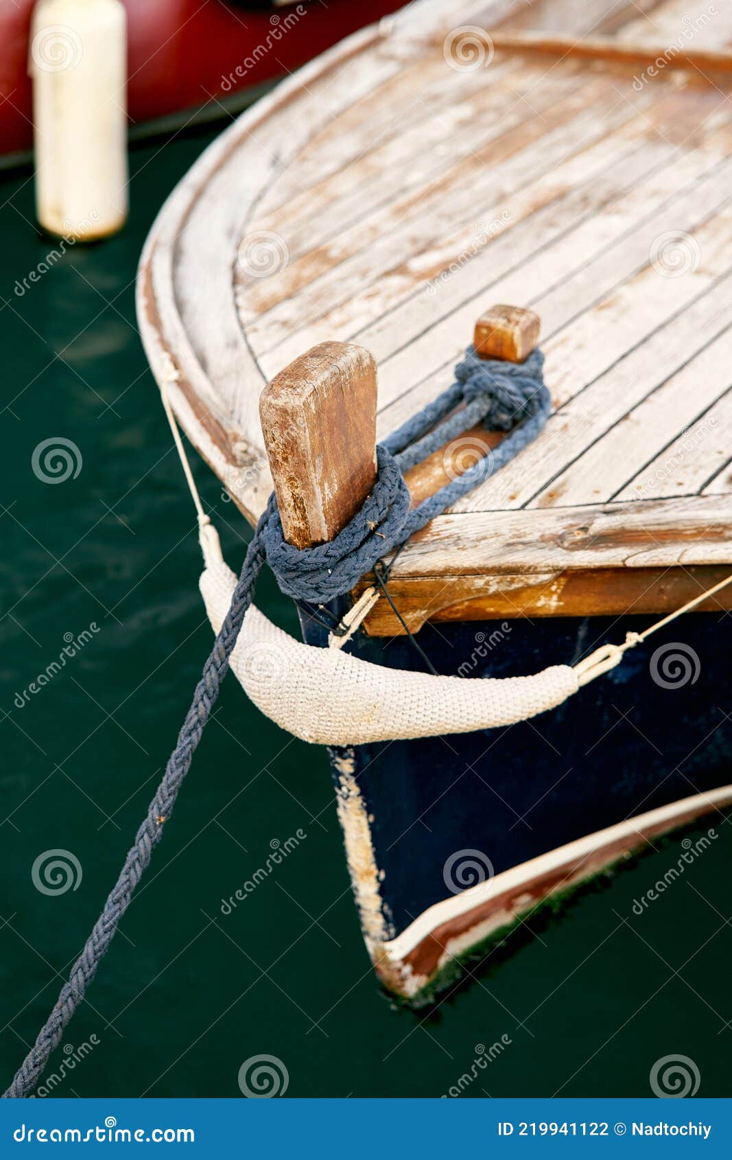 Bow of a Wooden Boat with an Anchor Rope Attached. Close-up Stock