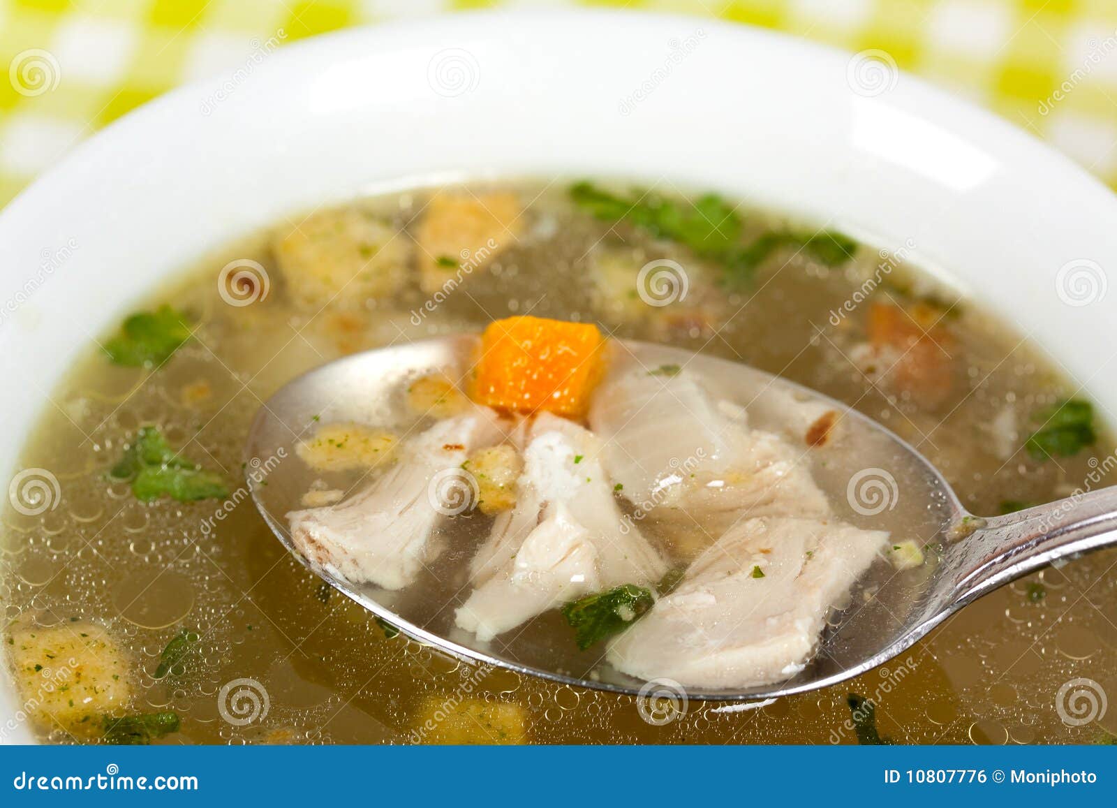 a bowl of chicken soup with selective focus