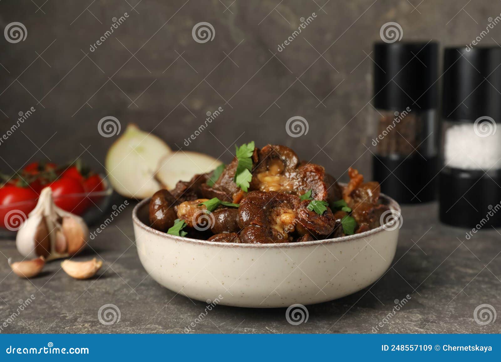 Bowl with Delicious Kidneys and Parsley on Grey Table Stock Image