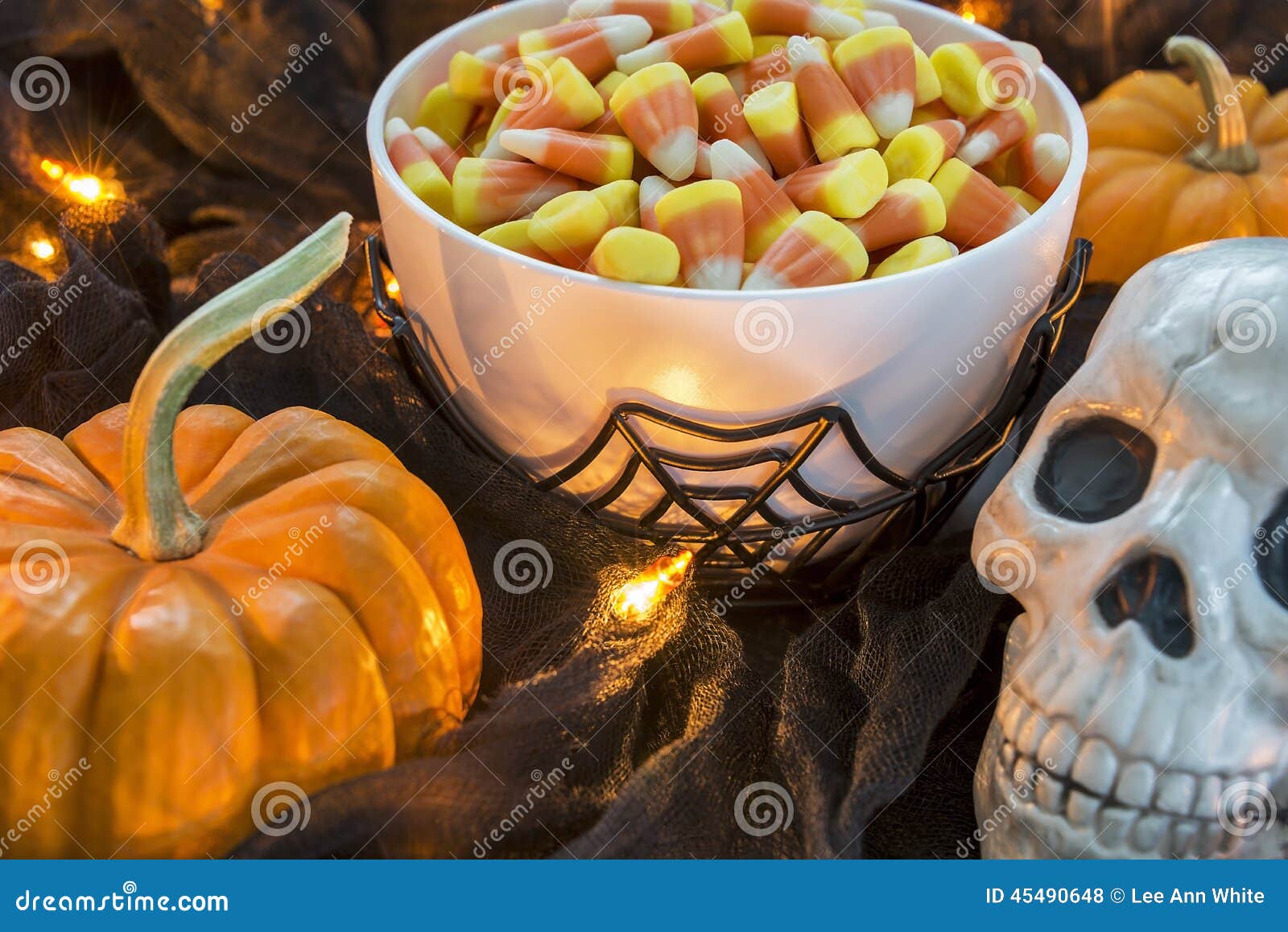 A Bowl Full of Halloween Candy Corn in a Spooky Setting Stock Photo