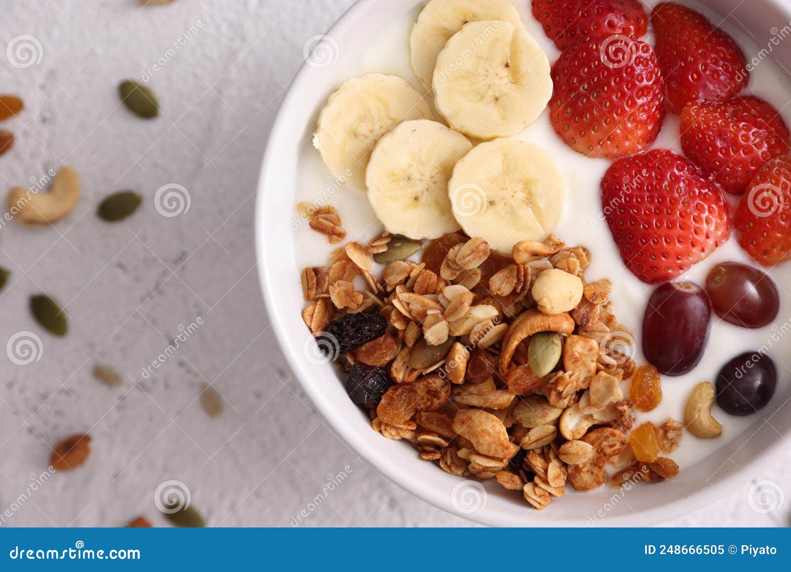 Bowl of Granola Cereal with Yogurt and Berries Isolated on White