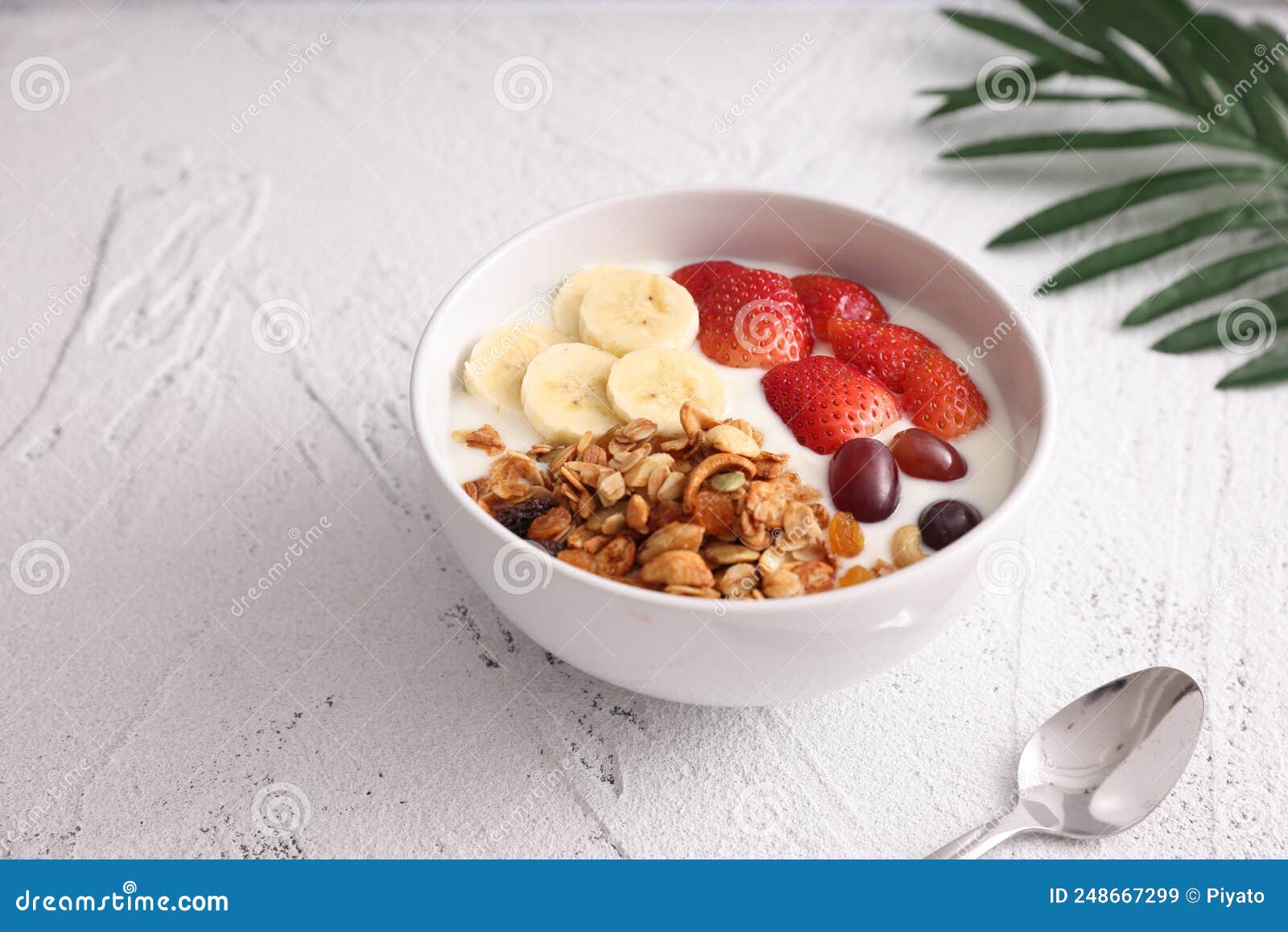 Bowl of Granola Cereal with Yogurt and Berries Isolated on White