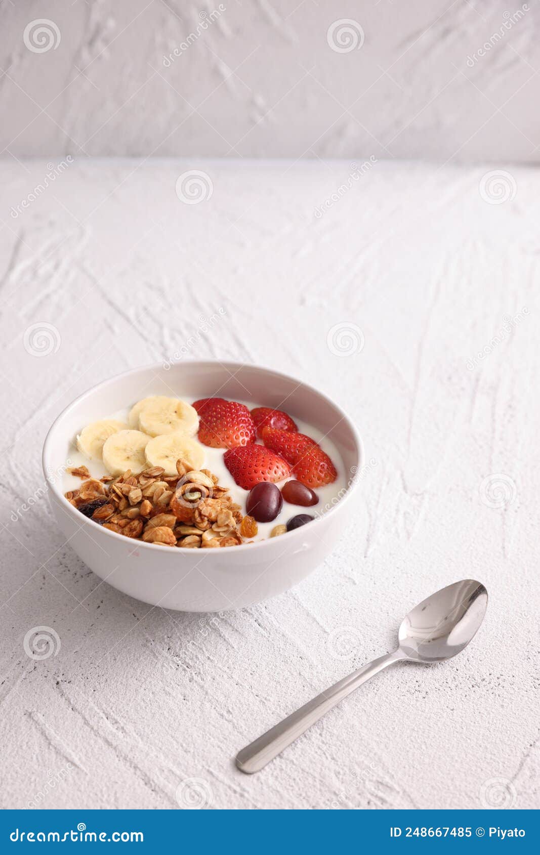 Bowl of Granola Cereal with Yogurt and Berries Isolated on White