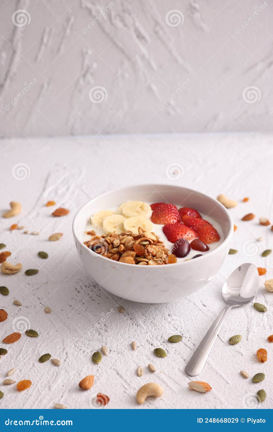 Bowl of Granola Cereal with Yogurt and Berries Isolated on White