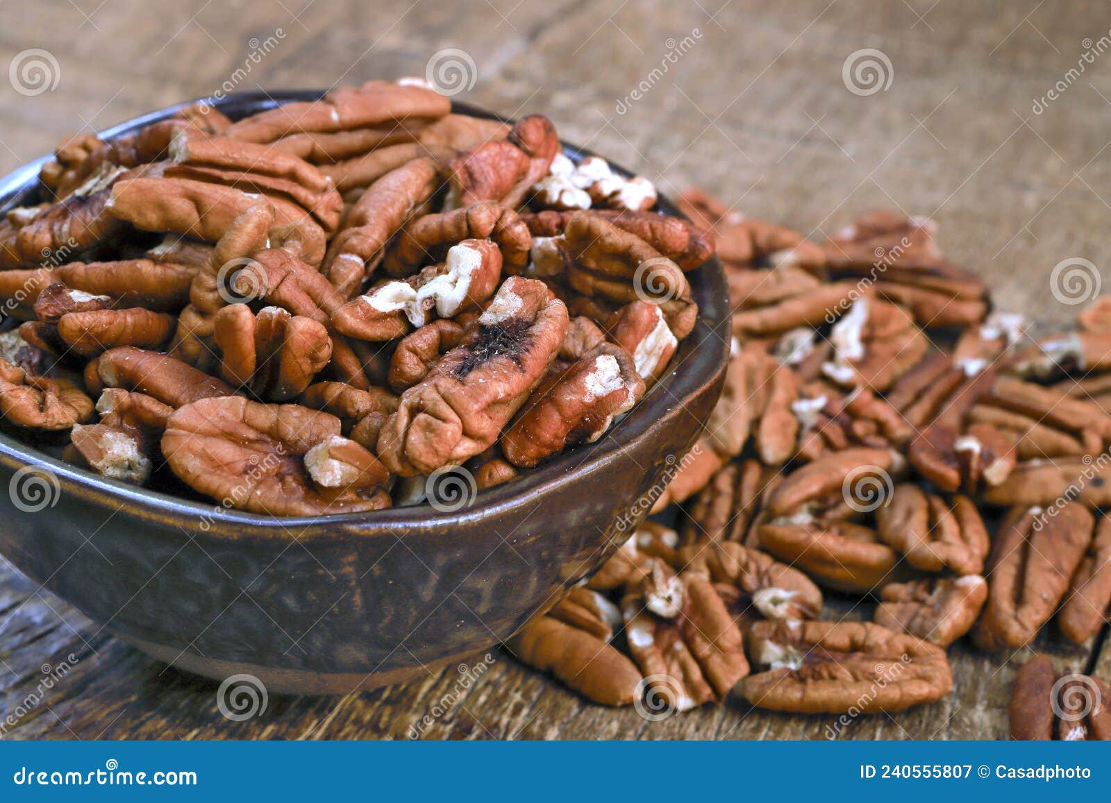 bowl with pecan on rustic wooden table