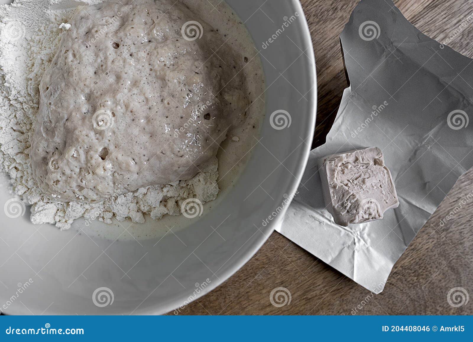 Bowl with Prepared Yeast Dough and a Piece of Fresh Yeast Stock Photo