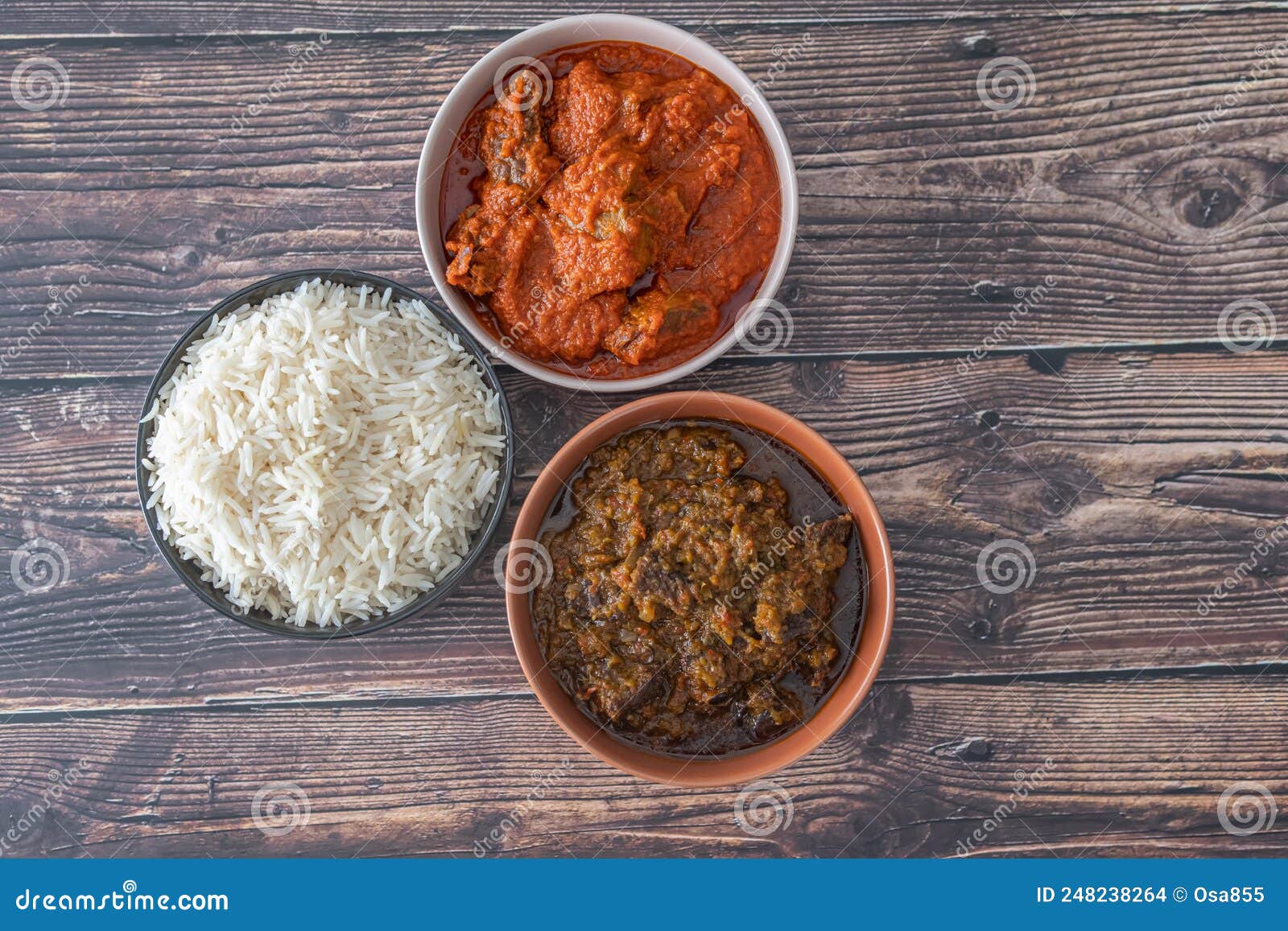 Bowl of Rice Served with Ofada and Pepper Tomato Stew Stock Photo