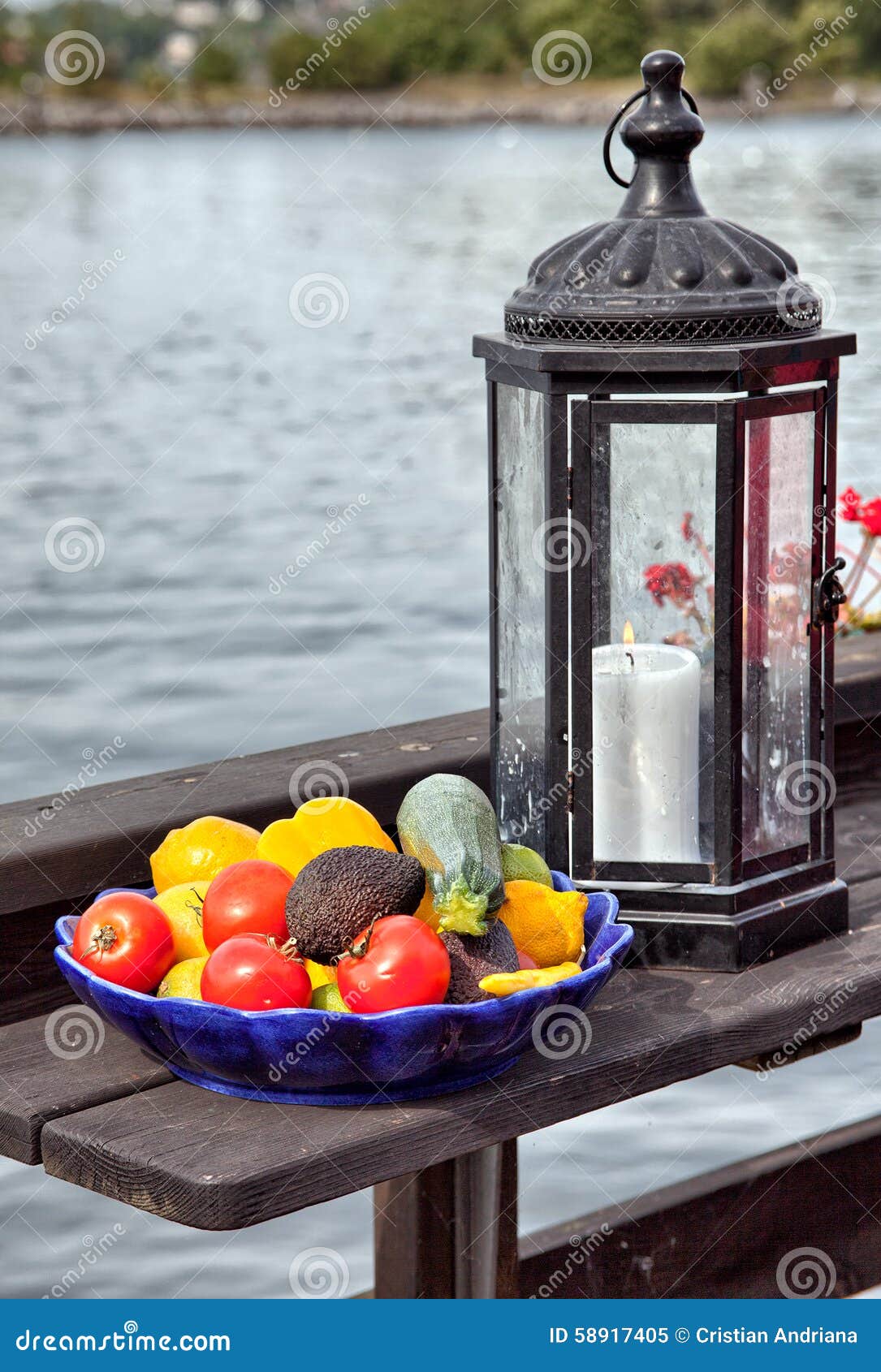 A Bowl of Vegetable and a Candle Lamp by the Lake Stock Image Image