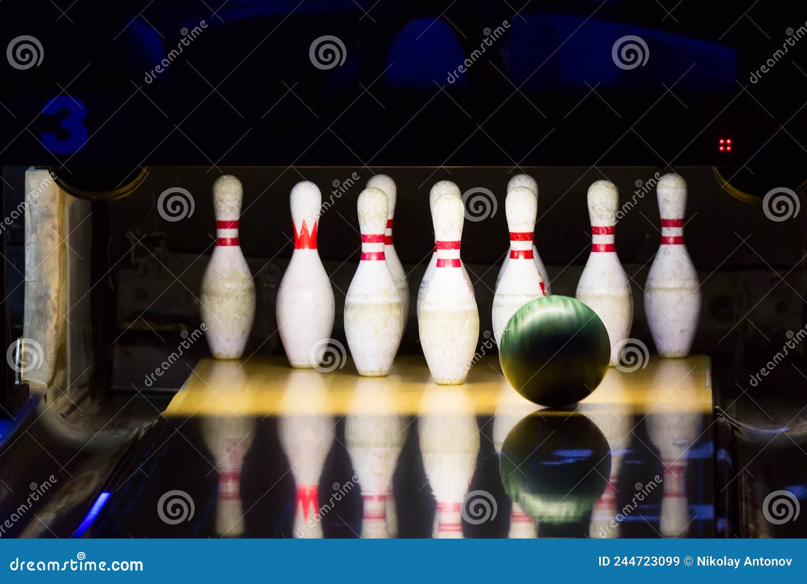 Bowling Alley. Green Bowling Ball Rolling into the Pins Stock Image