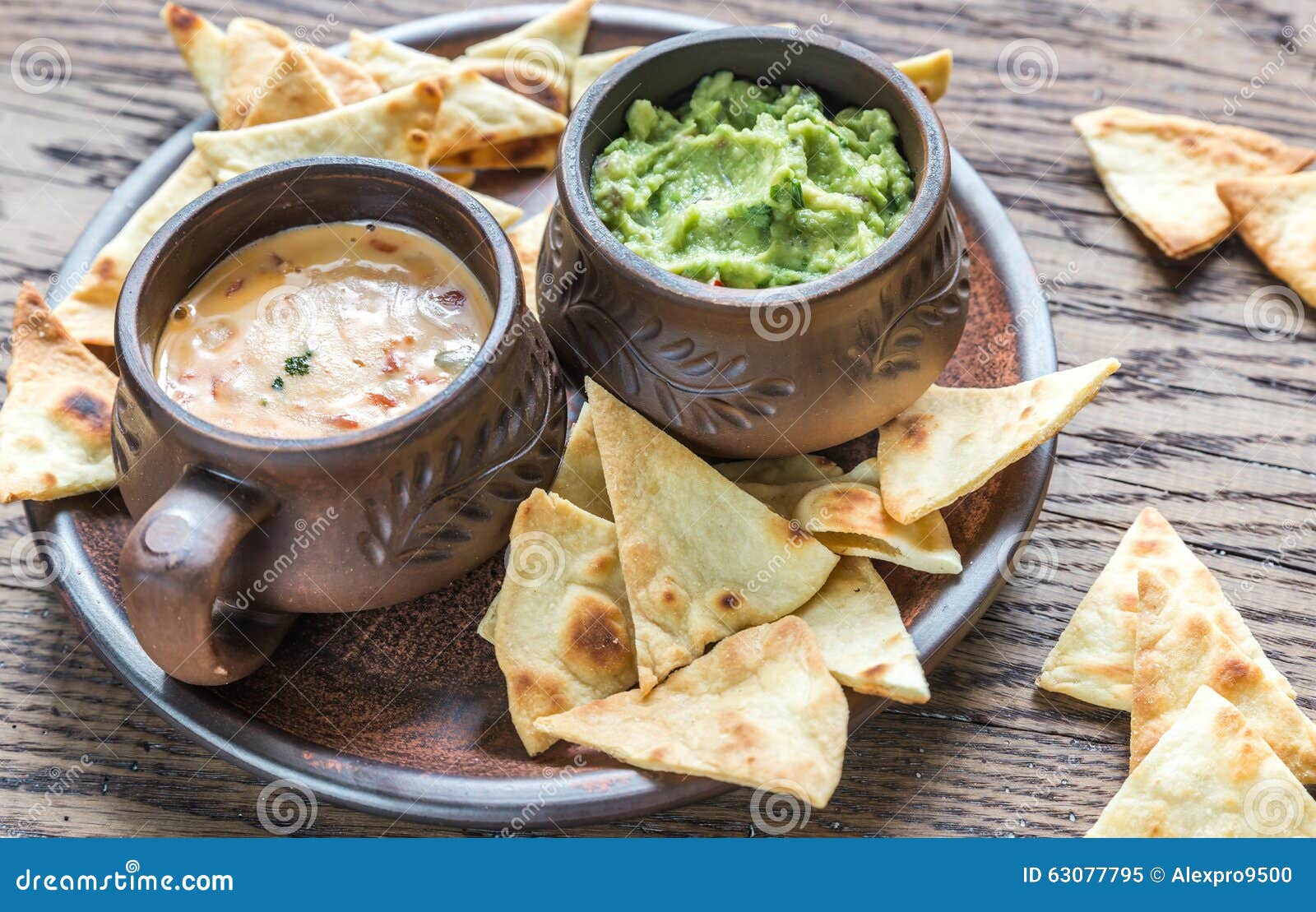 bowls of guacamole and queso with tortilla chips
