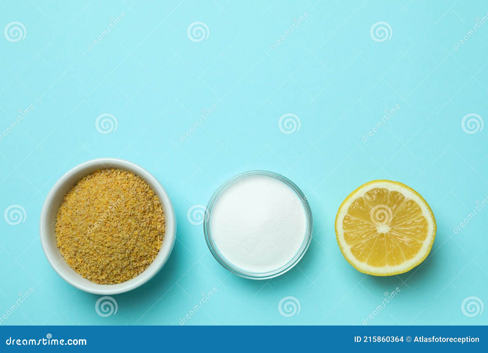 Bowls with Mustard Powder and Acid Powder, and Half of Lemon on Blue