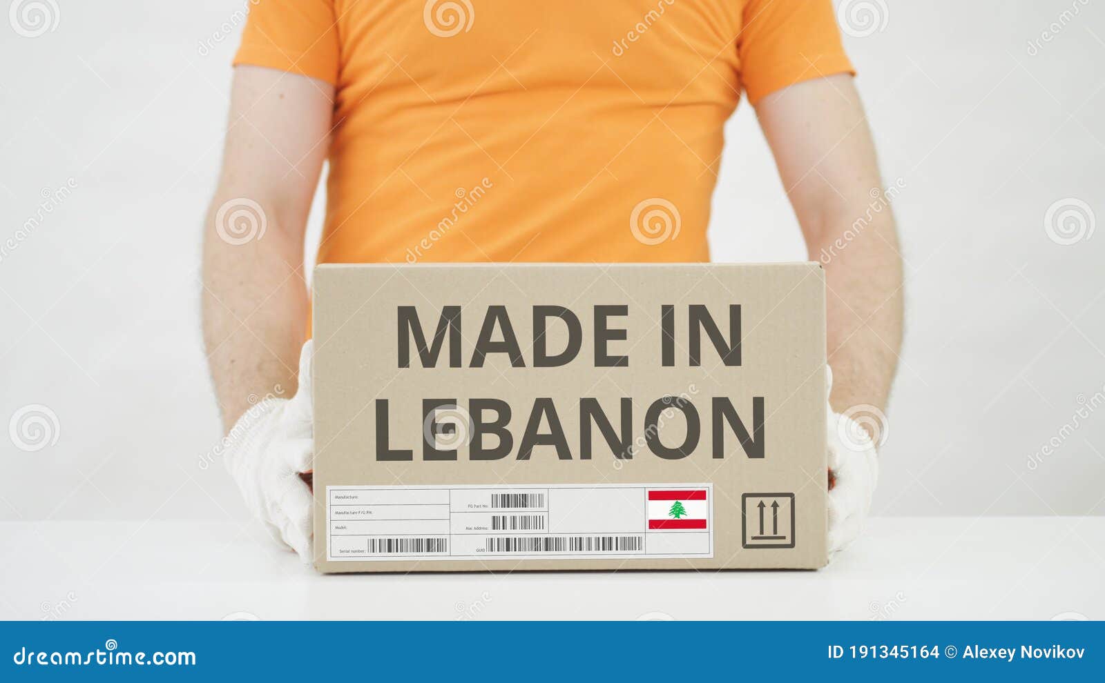 Box with MADE in LEBANON Text Being Placed on the Table Stock Photo