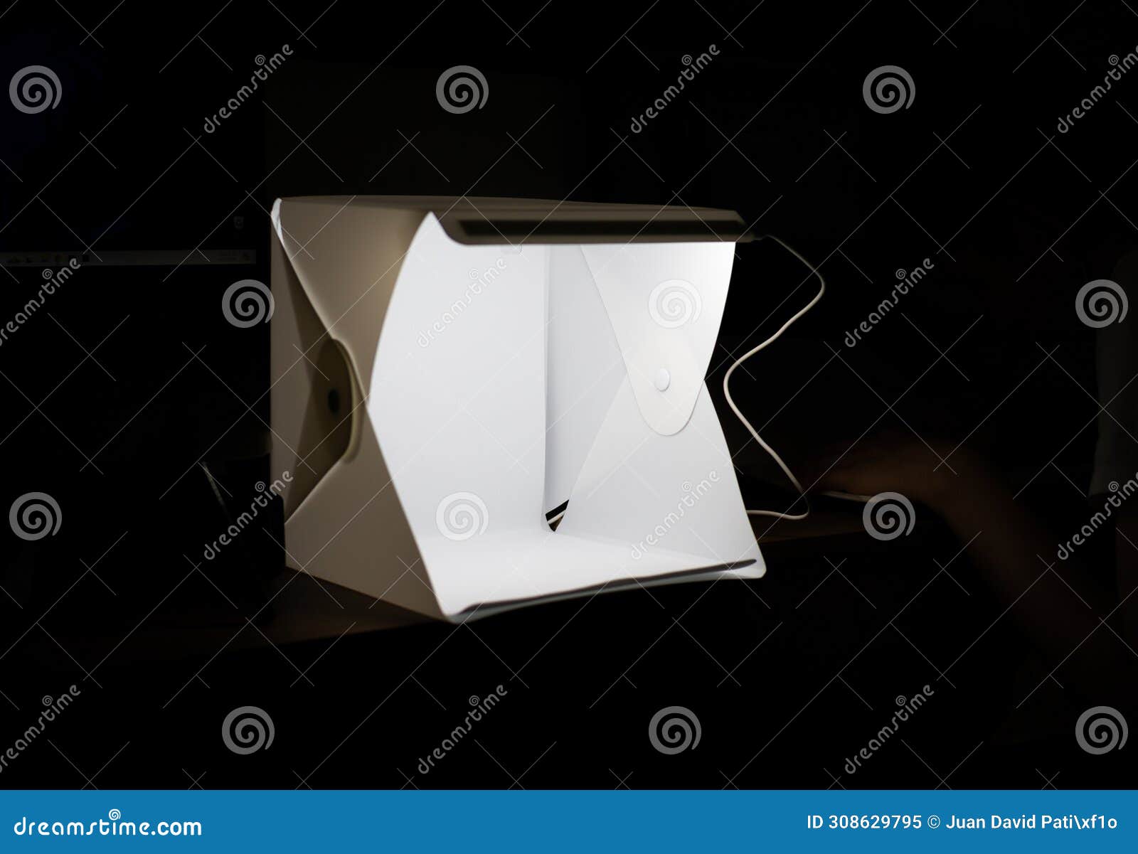 box for product photography illuminating in the middle of the darkness