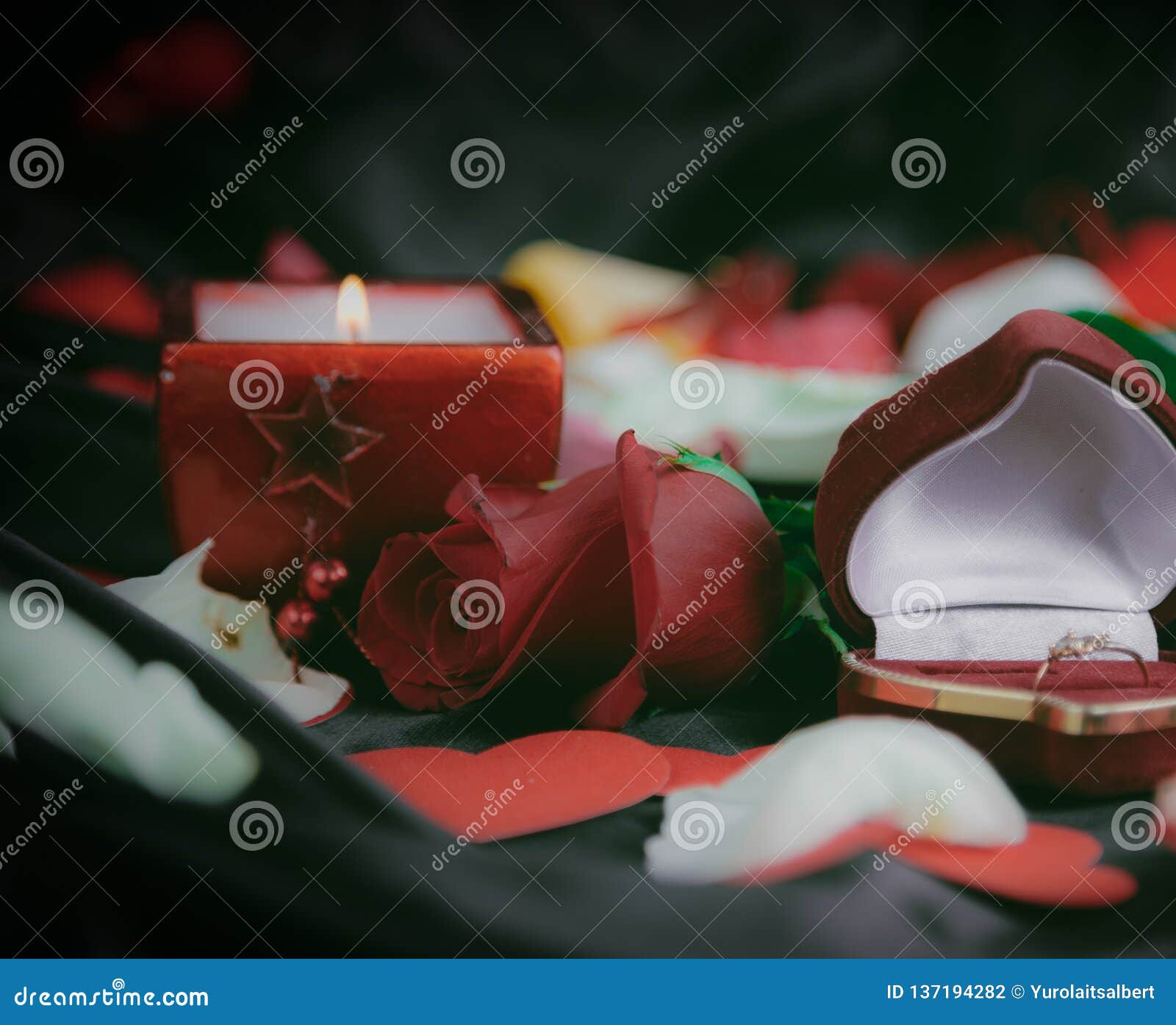 Box with Ring and Rose Petals in Black Silk Background Stock Photo ...