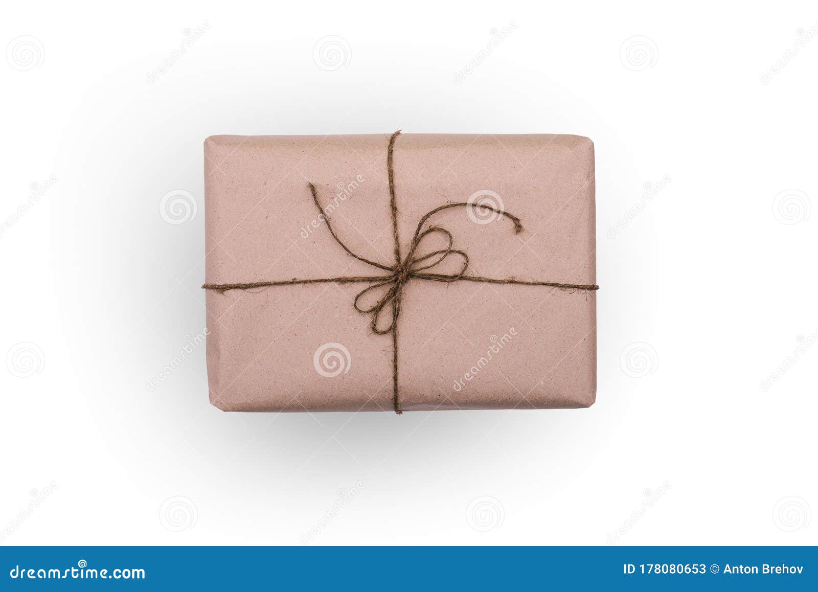 The Box is Wrapped in Brown Paper and Tied with Thread. Rectangular Packaging Isolated on a