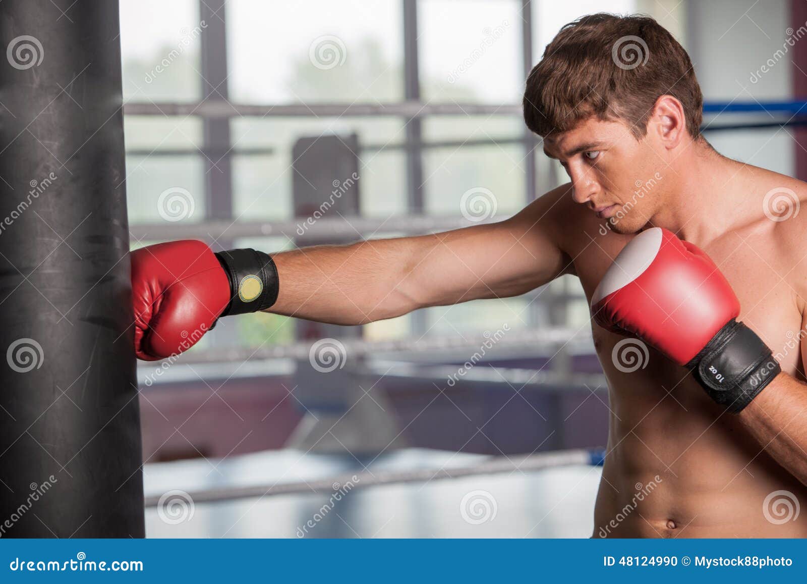 Boxer Doing Some Training on Punching Bag at Gym. Stock Photo Image