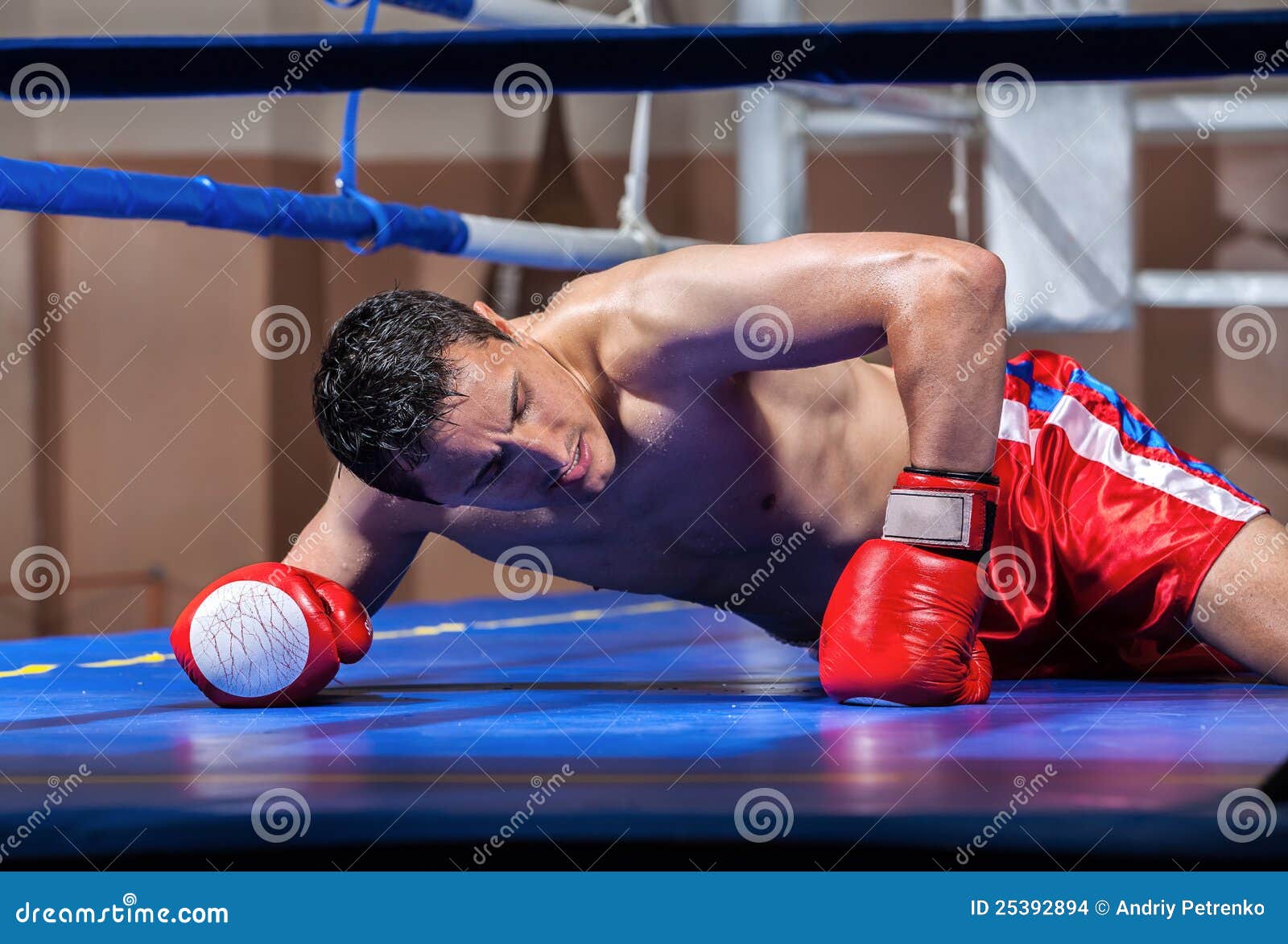 Pretty Female Boxer Knocked Out Laying On The Floor Stock Photo