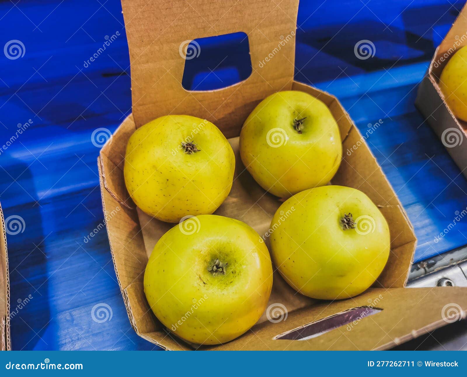 Boxes of Golden Delicious Apples on the Conveyor Belt Ready for Packing