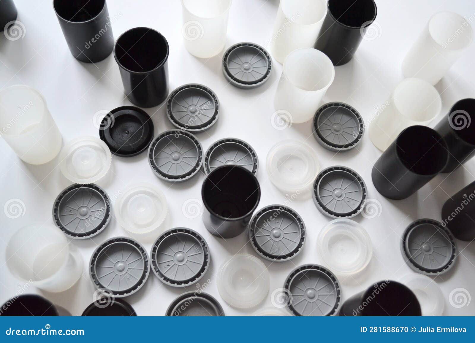 Boxes with Lids from Rolls of 35mm Negative Film on White Background