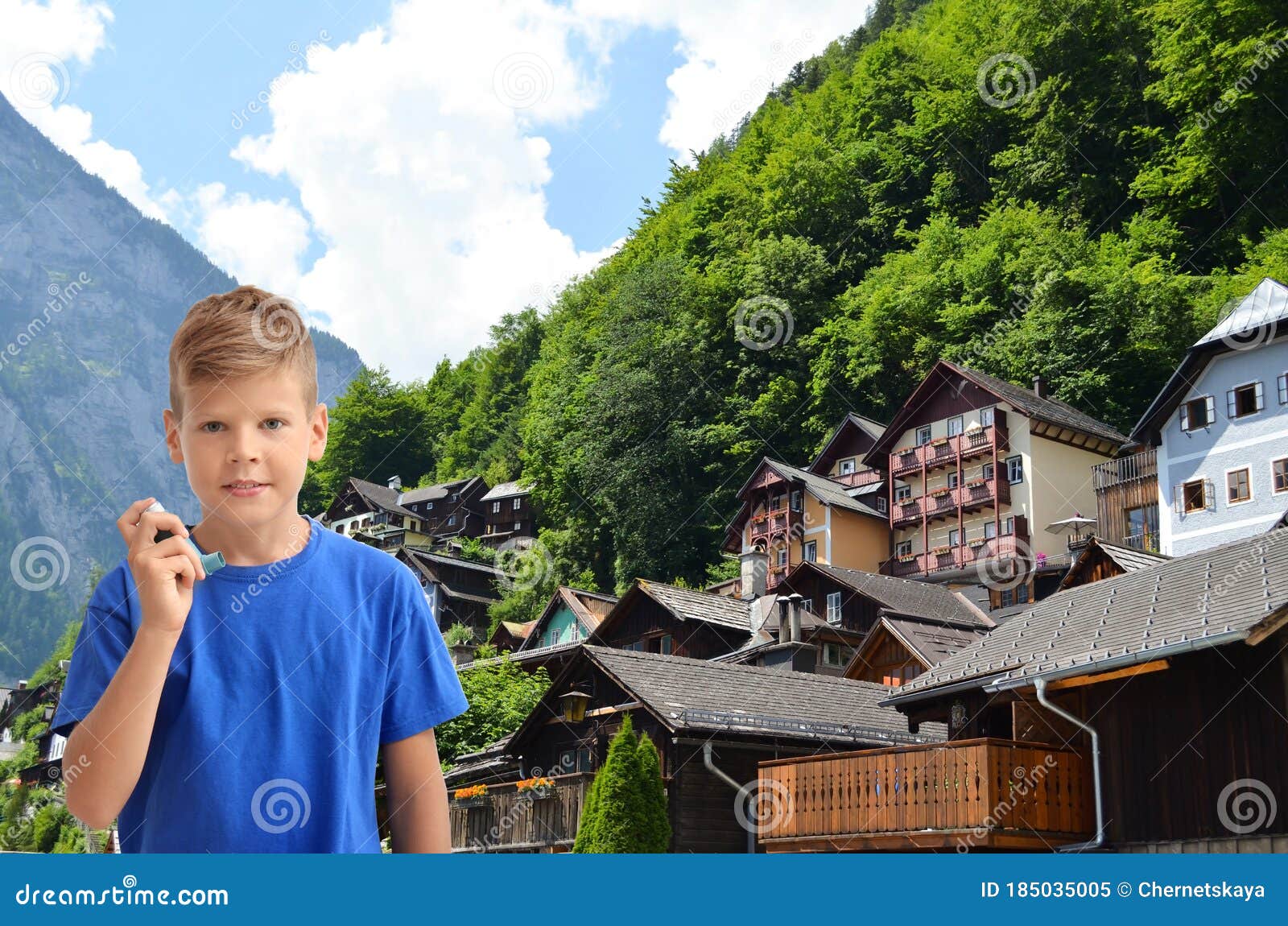 boy with asthma inhaler and mountain village on background. first emergency medical aid