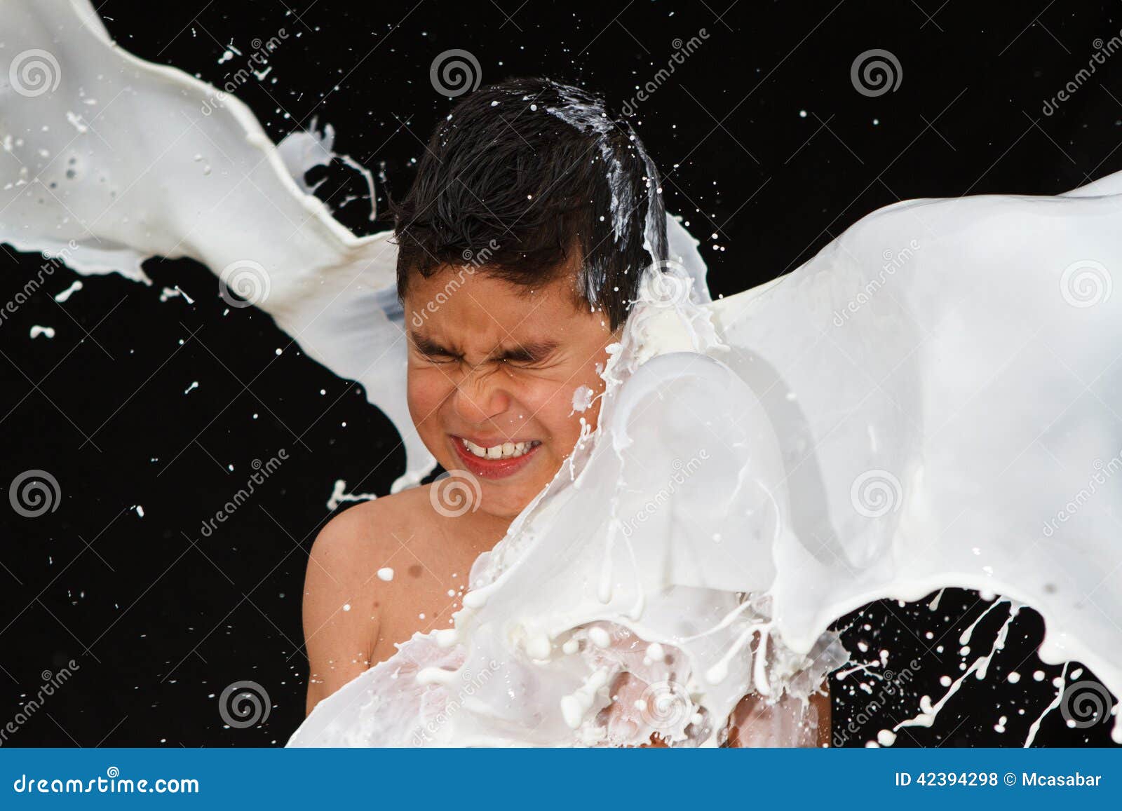 boy being splashed by milk