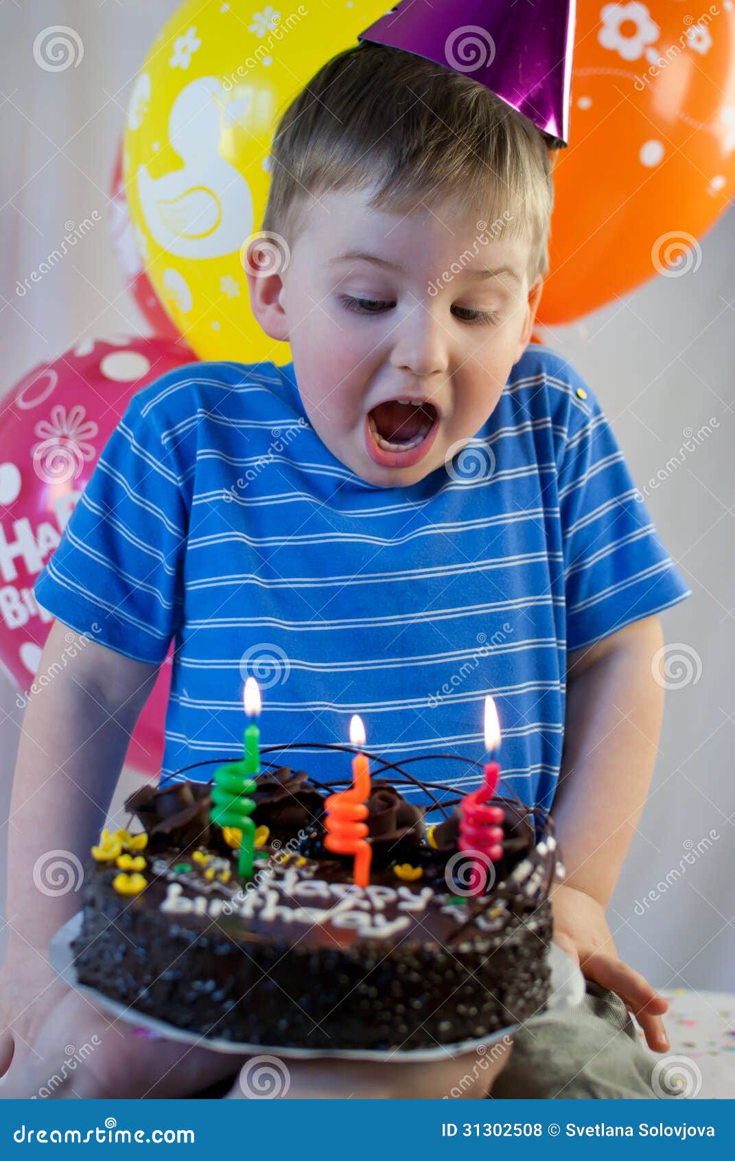 Boy blows out the candles stock photo. Image of birth 31302508