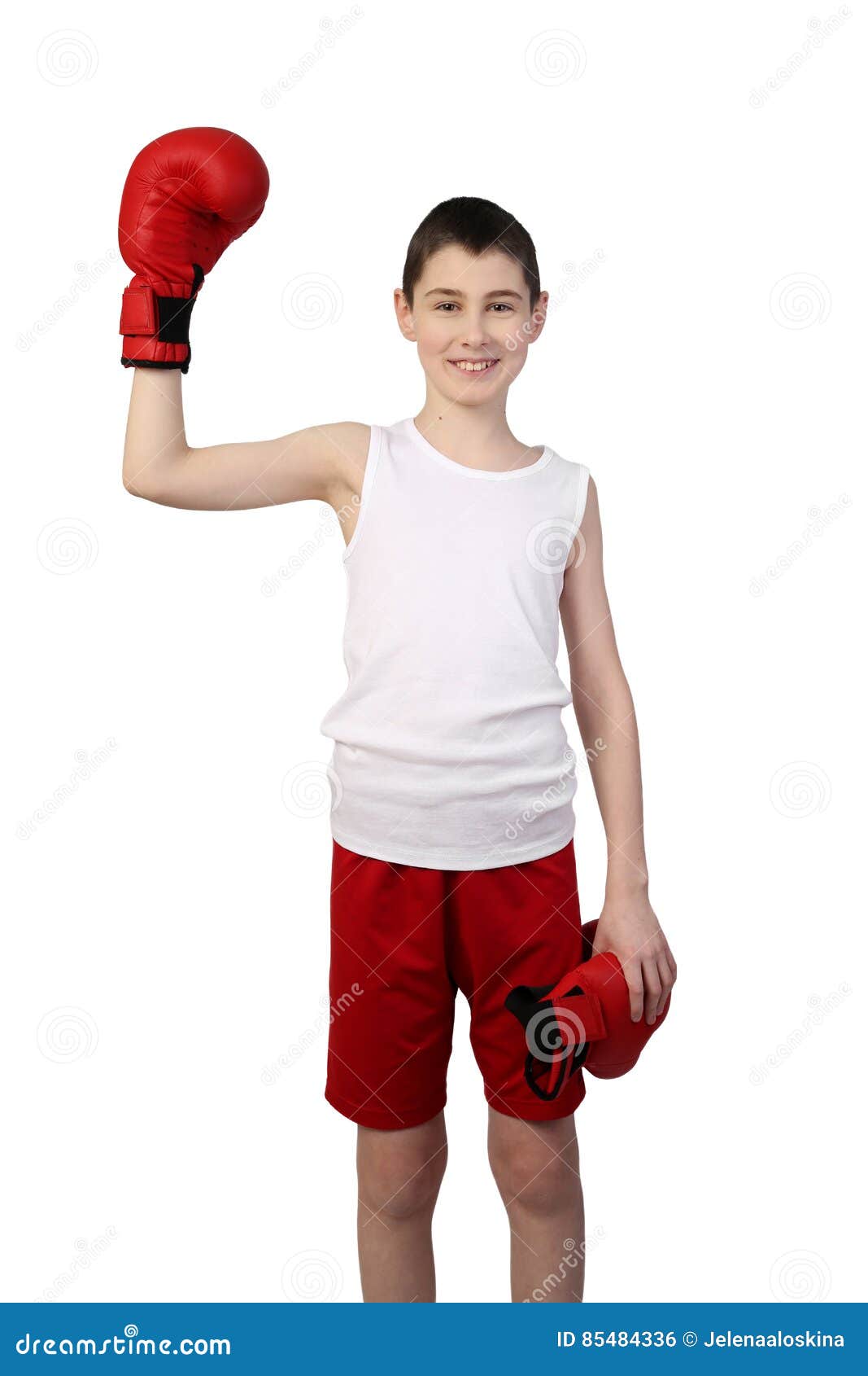 Boy boxer winner. Boy in sleeveless shirt and sport shorts stays with raised hand in boxing glove isolated on white background - young boxer win