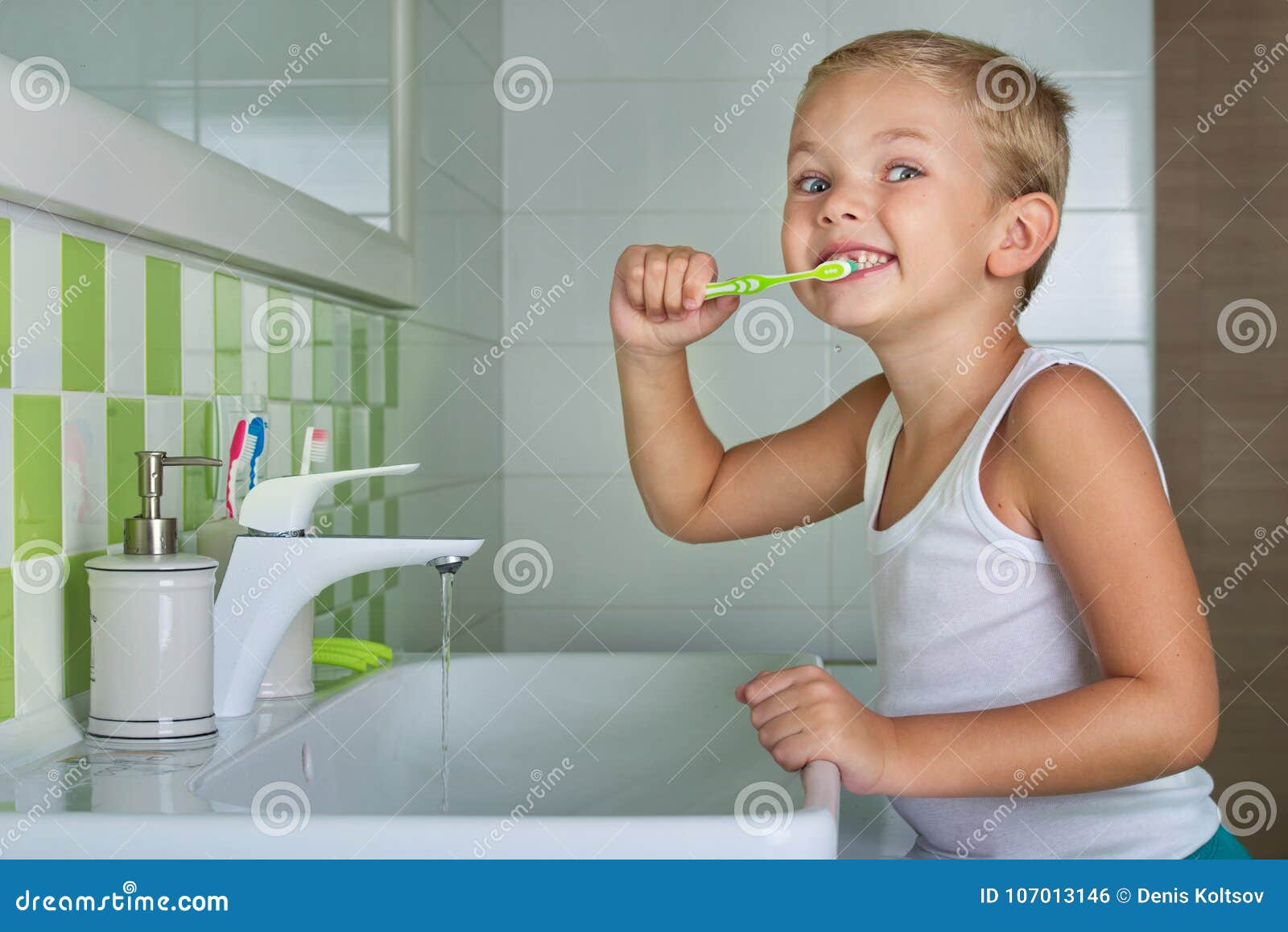 Boy Brushing Teeth in the Bathroom. Stock Photo Image of happy, paste