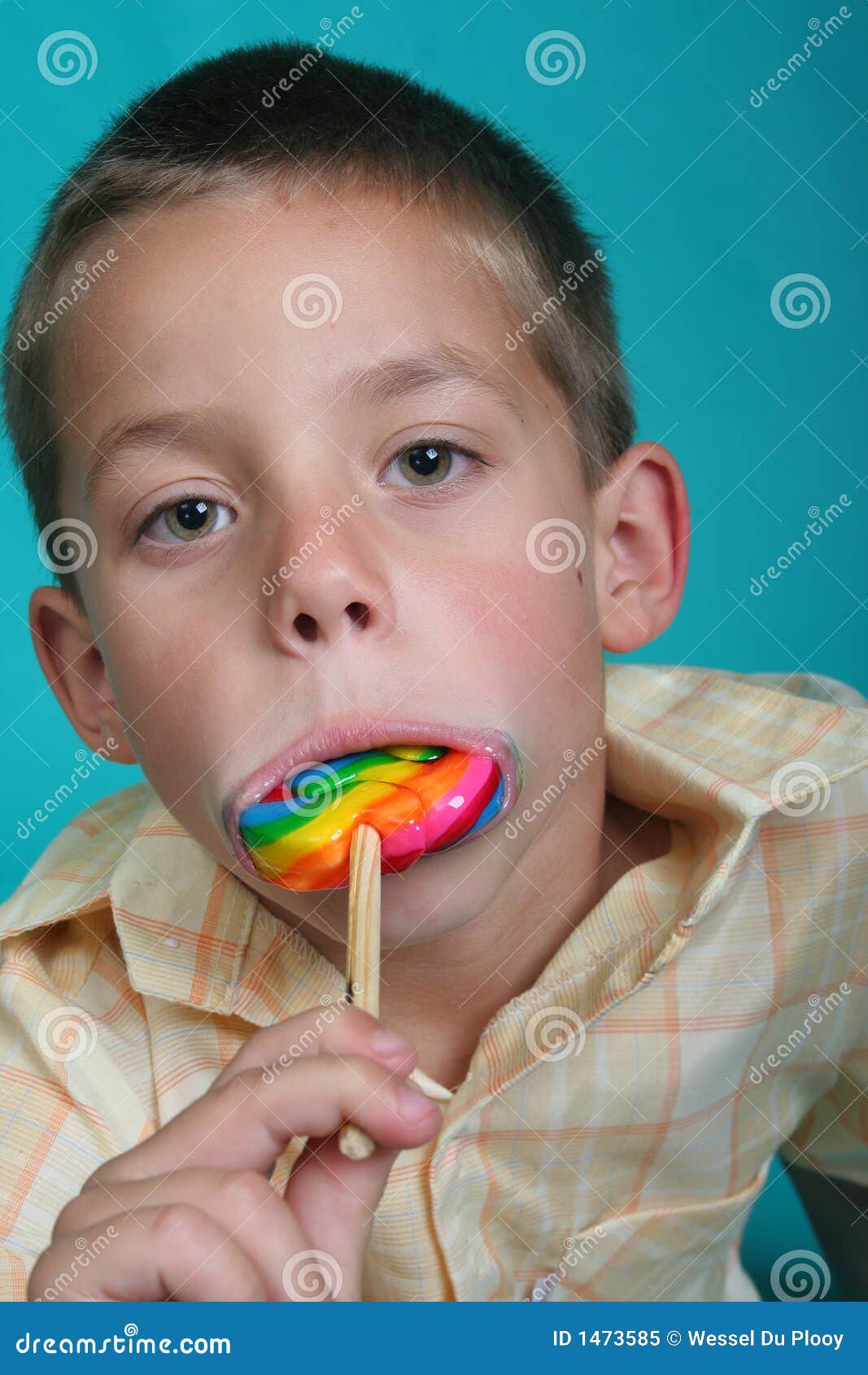 Boy with candy stock image. Image of teal, male, candy 1473585