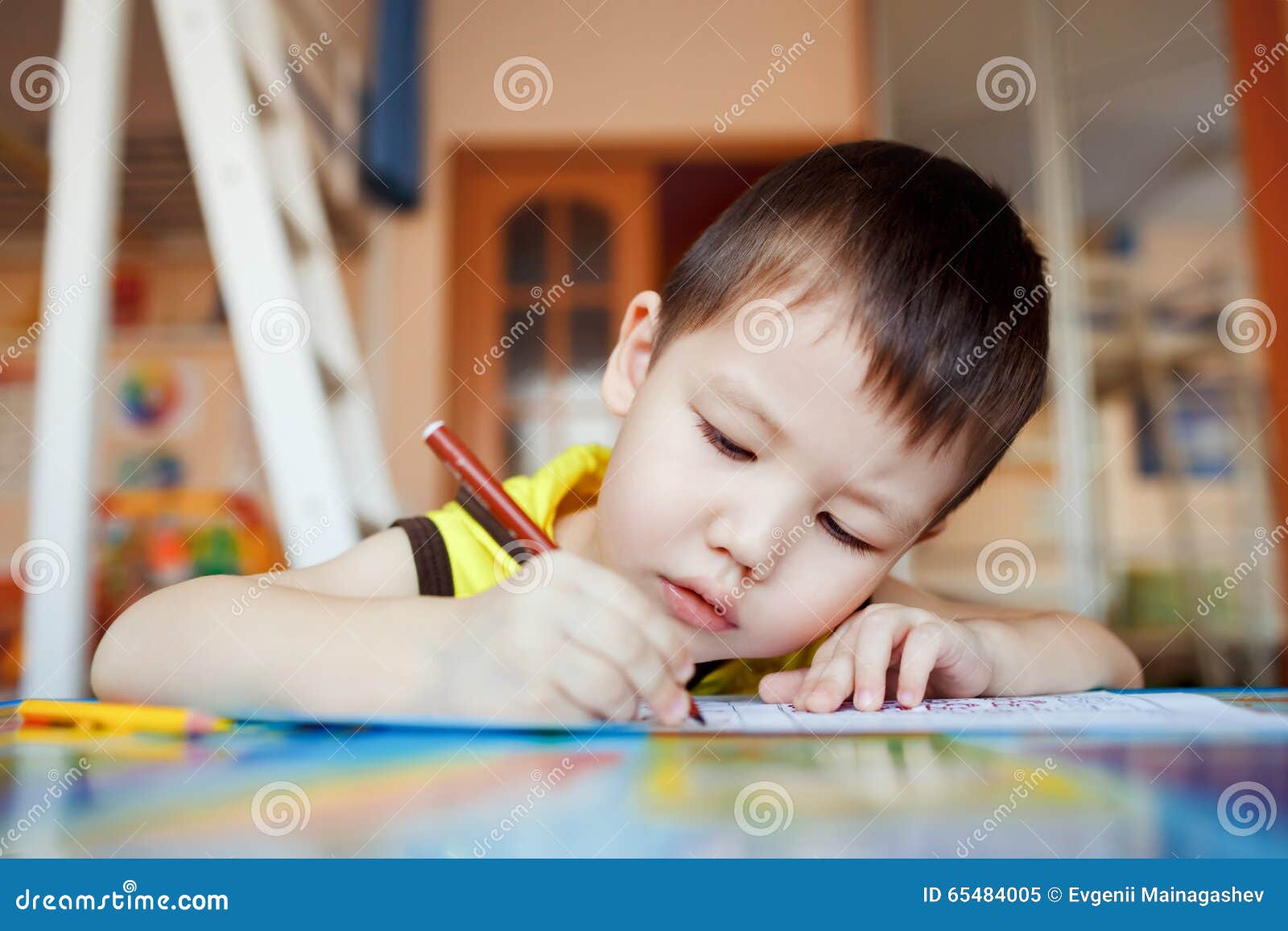the boy carefully and intently draws in a special