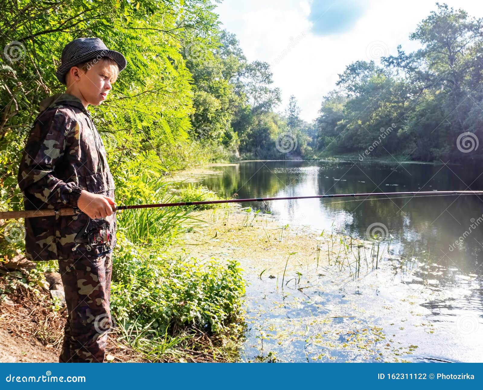 Boy Catches a Fish on a Spinning Stock Photo Image of bass, angler