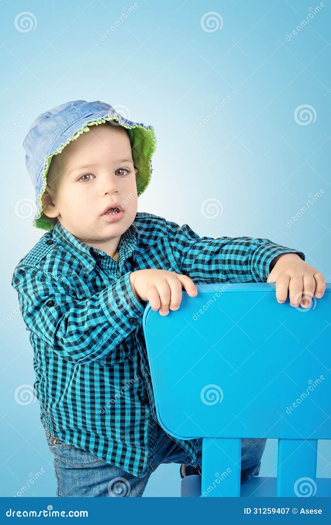 Boy with chair stock image. Image of surprised, brown 31259407