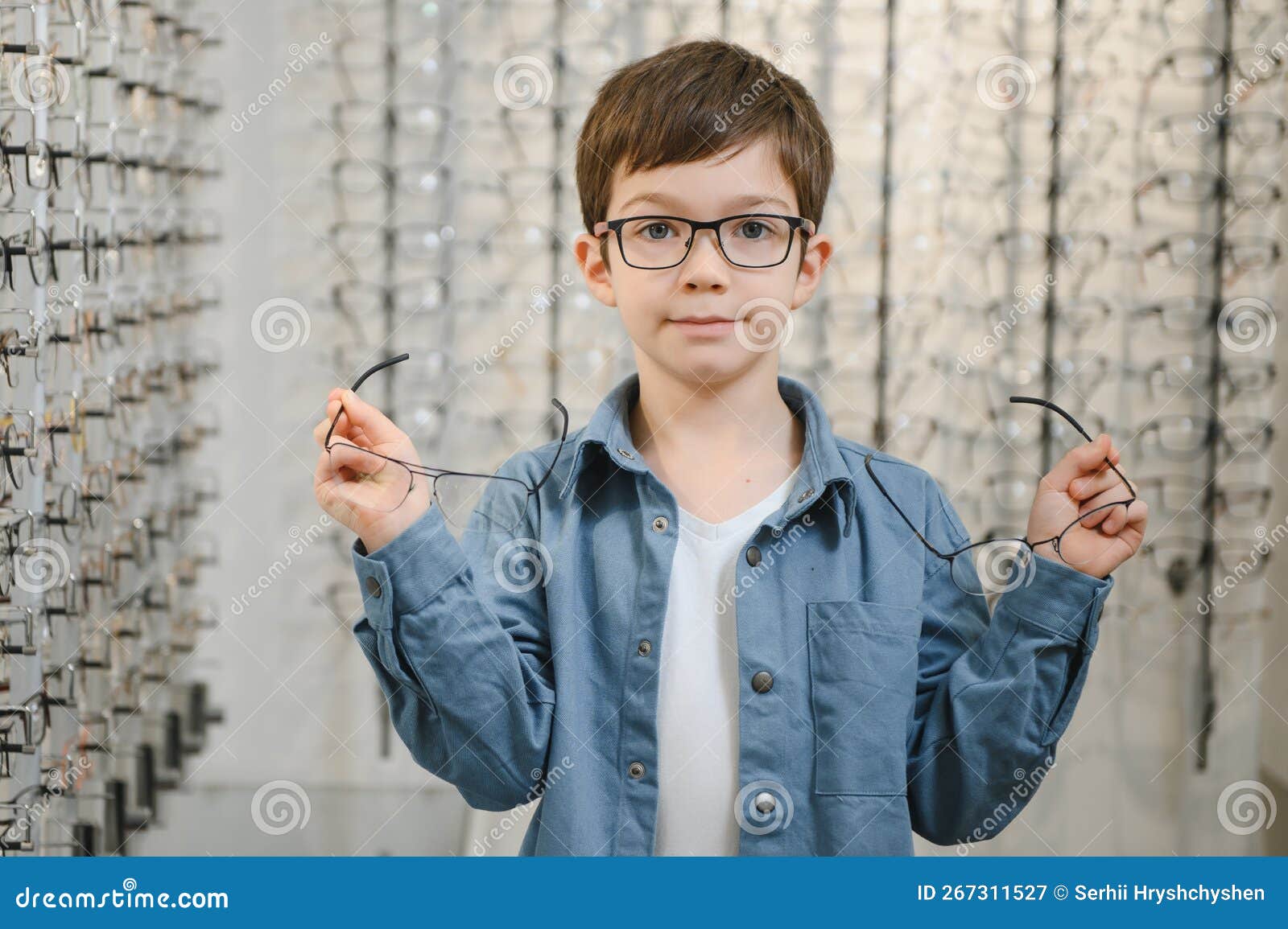 Boy Choosing Glasses in Optics Store. Stock Image Image of people
