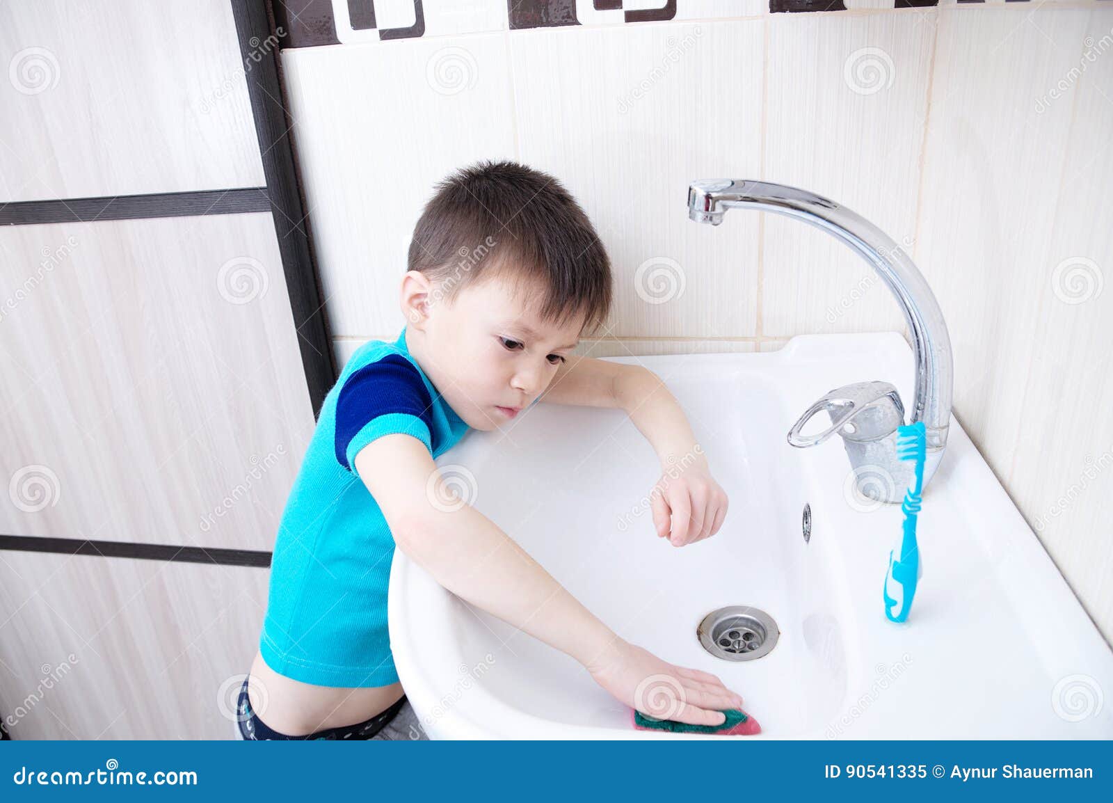 boy cleaning in bathroom wash sink, child doing up housework helping mother with sanitary cleanness of home