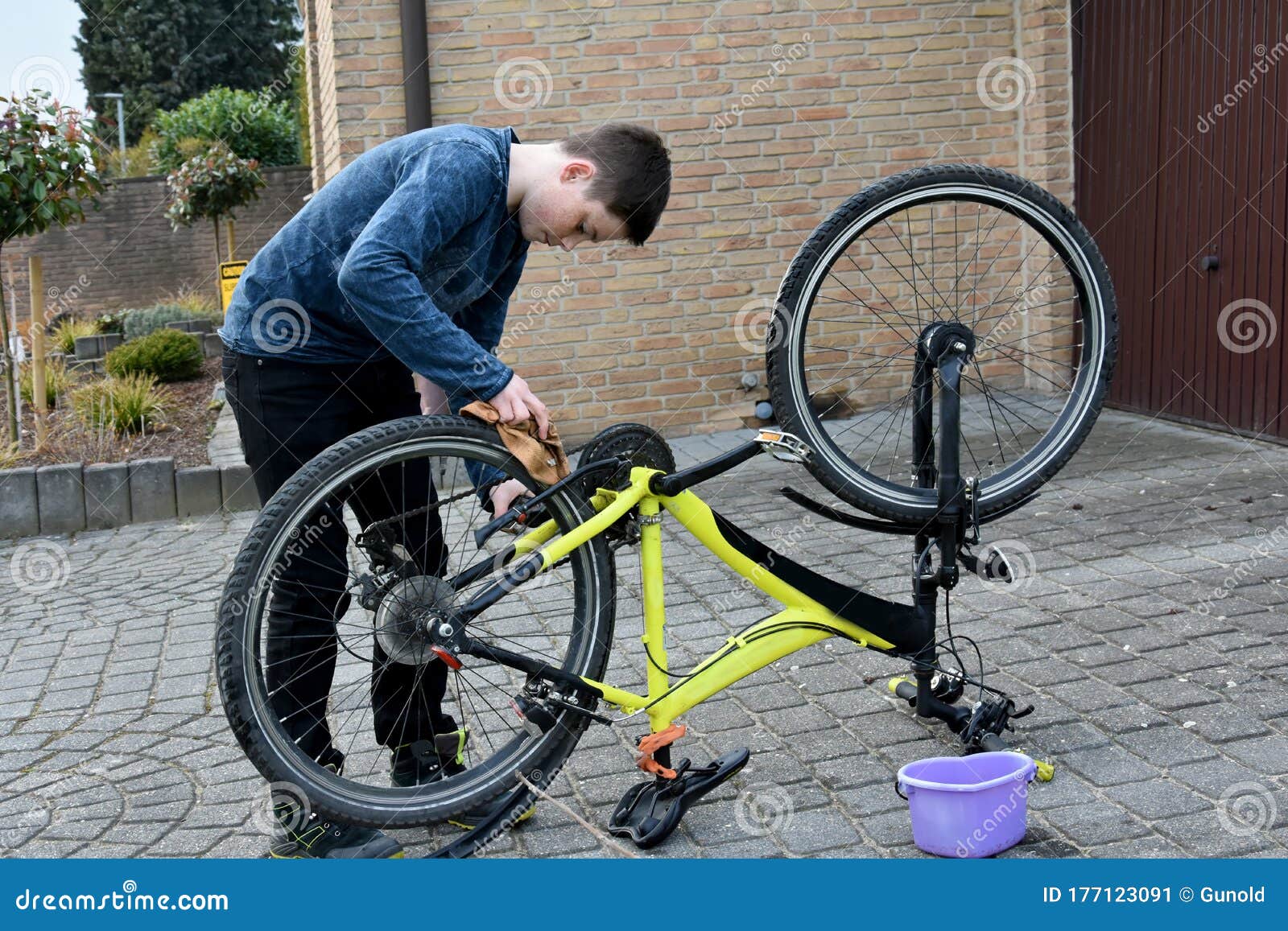 Boy Cleans Bike he Works Meticulously Stock Image Image of standing