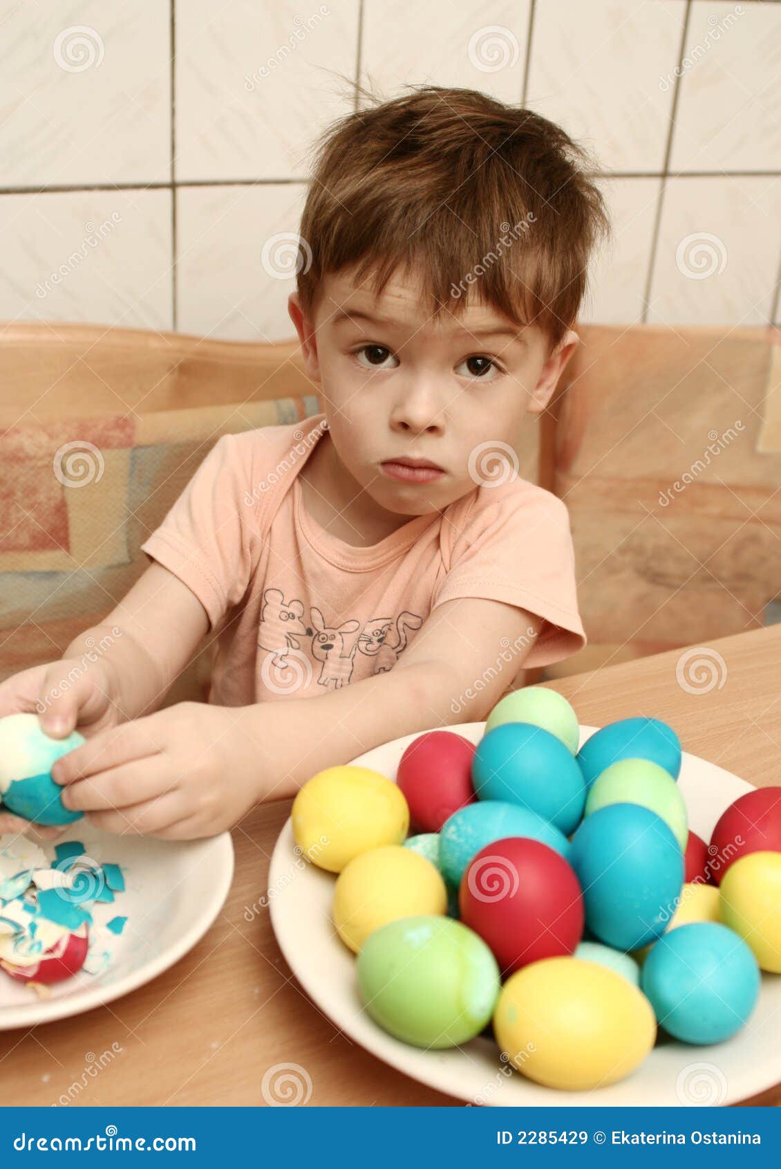the boy cleans easter eggs