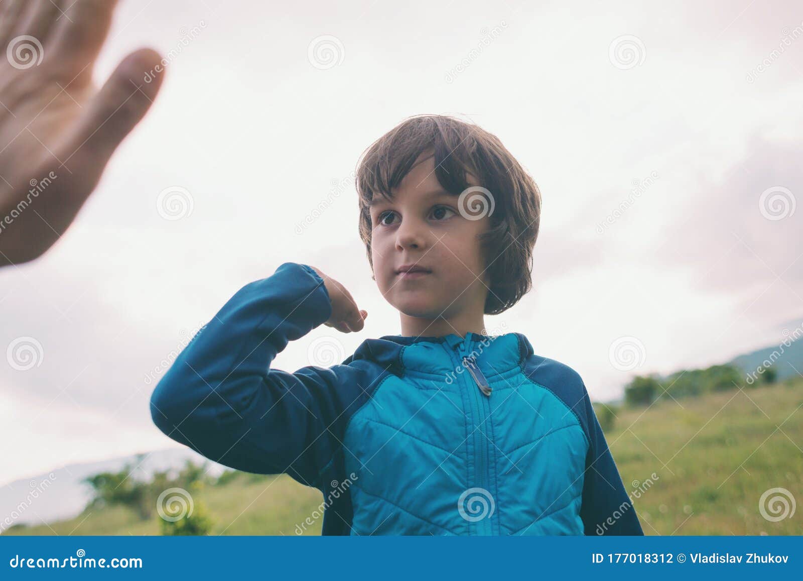 A Boy Climbed To the Top of the Mountain and Gives Five Stock Photo ...