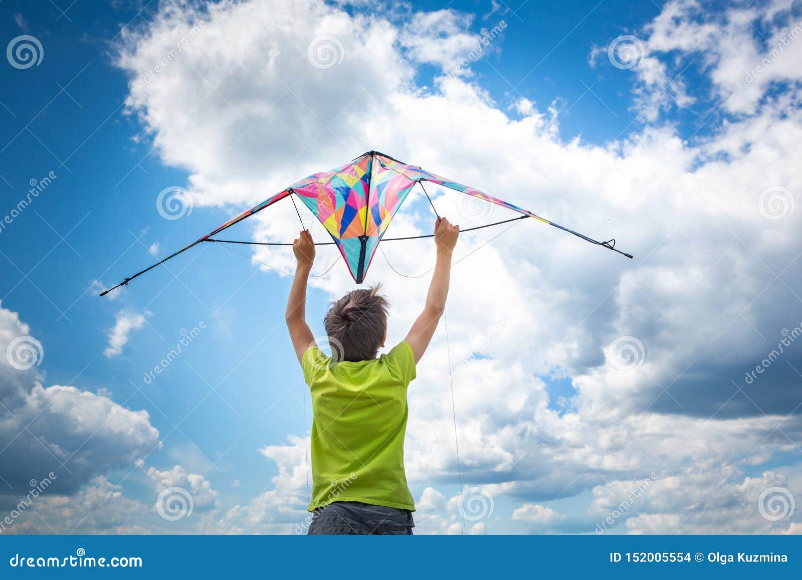 A Boy with a Colorful Kite in His Hands Against the Blue Sky with ...