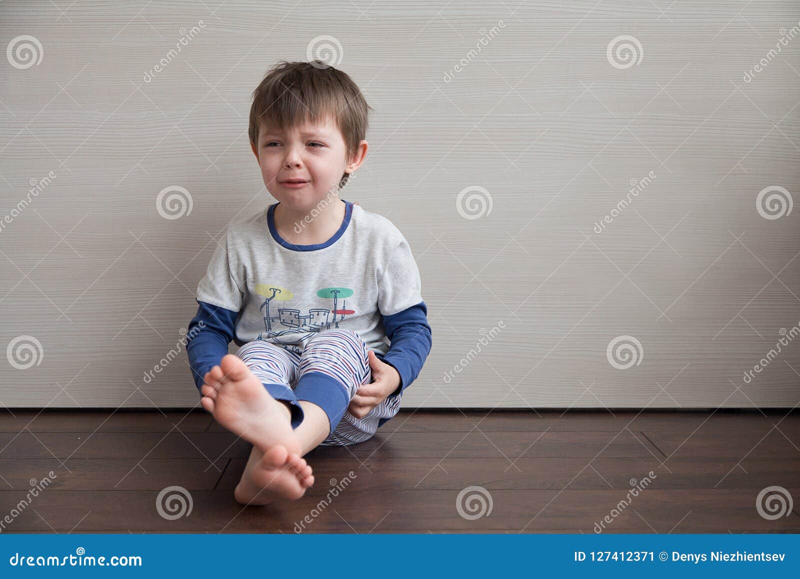 The Boy Is Crying. The Child Is Sitting On The Floor. Stock Image Image of childhood, toddler