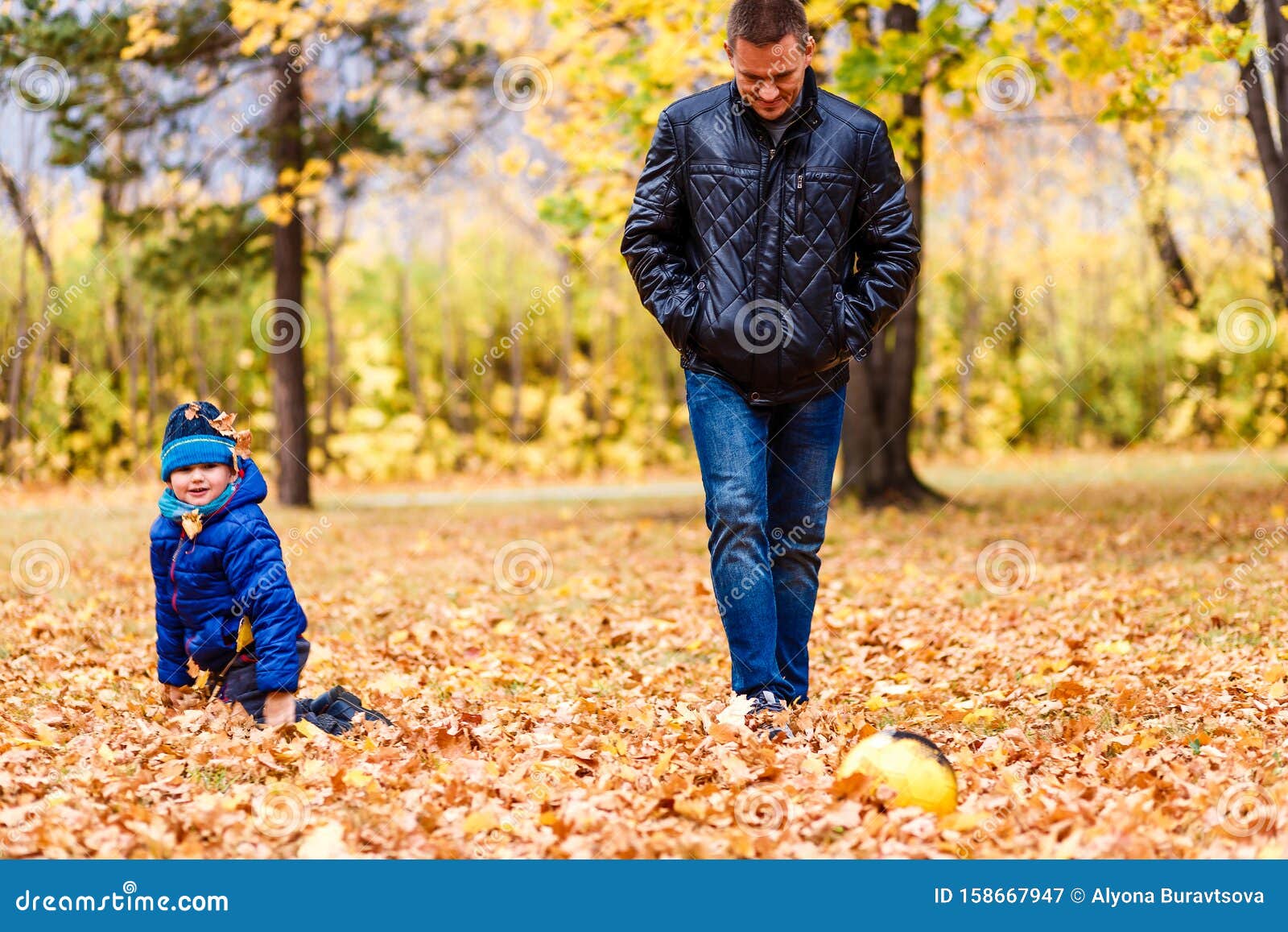 Boy and dad kick ball stock image. Image of adult, healthy 158667947