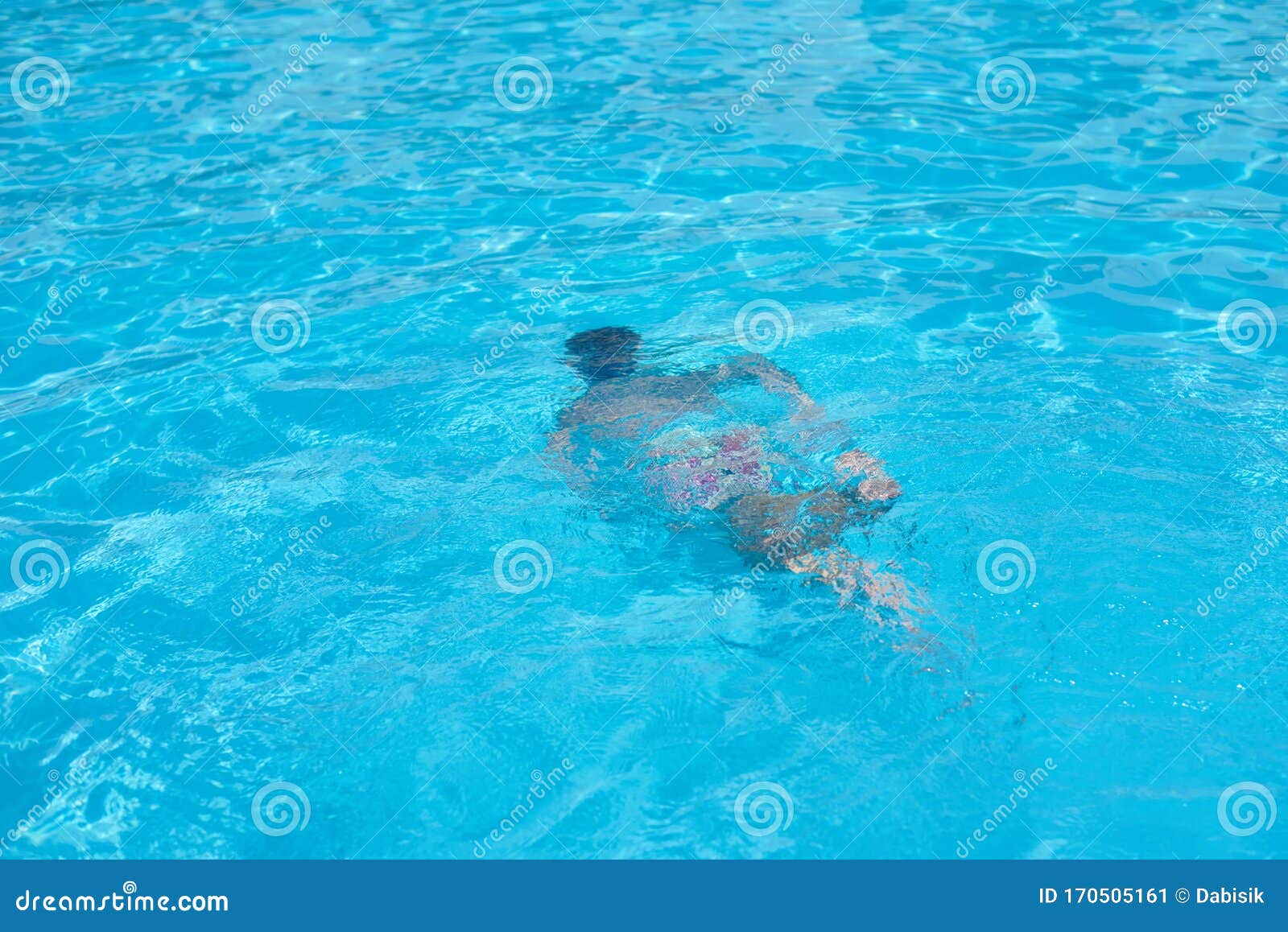 Child In Snorkeling Mask Dive Underwater In Blue Sea 
