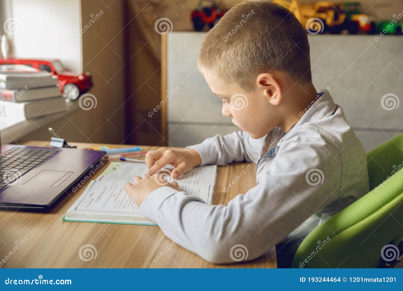The Boy Does His Homework at Home. Online Training Stock Photo - Image