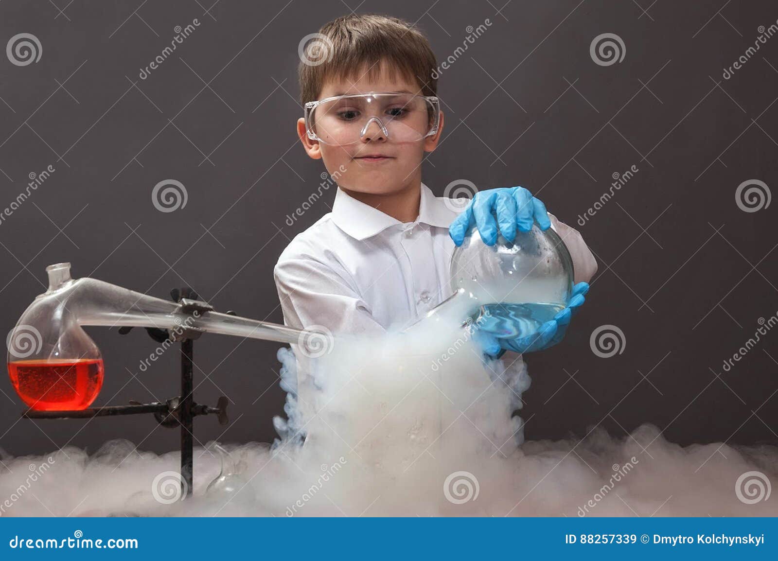 Boy Doing Experiments in the Laboratory. Experiments with Liquid