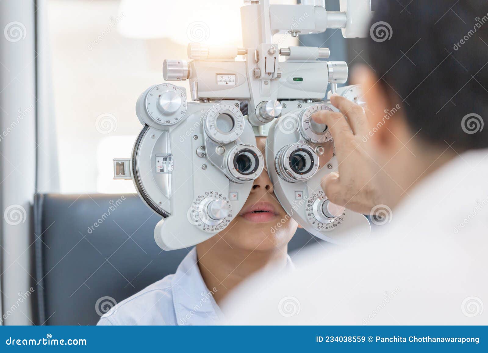 boy doing eye test checking examination with optometrist in optical shop, optometrist doing sight testing for child patient in