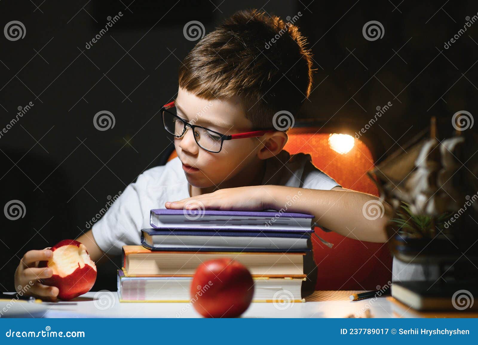 he does his homework in the evening