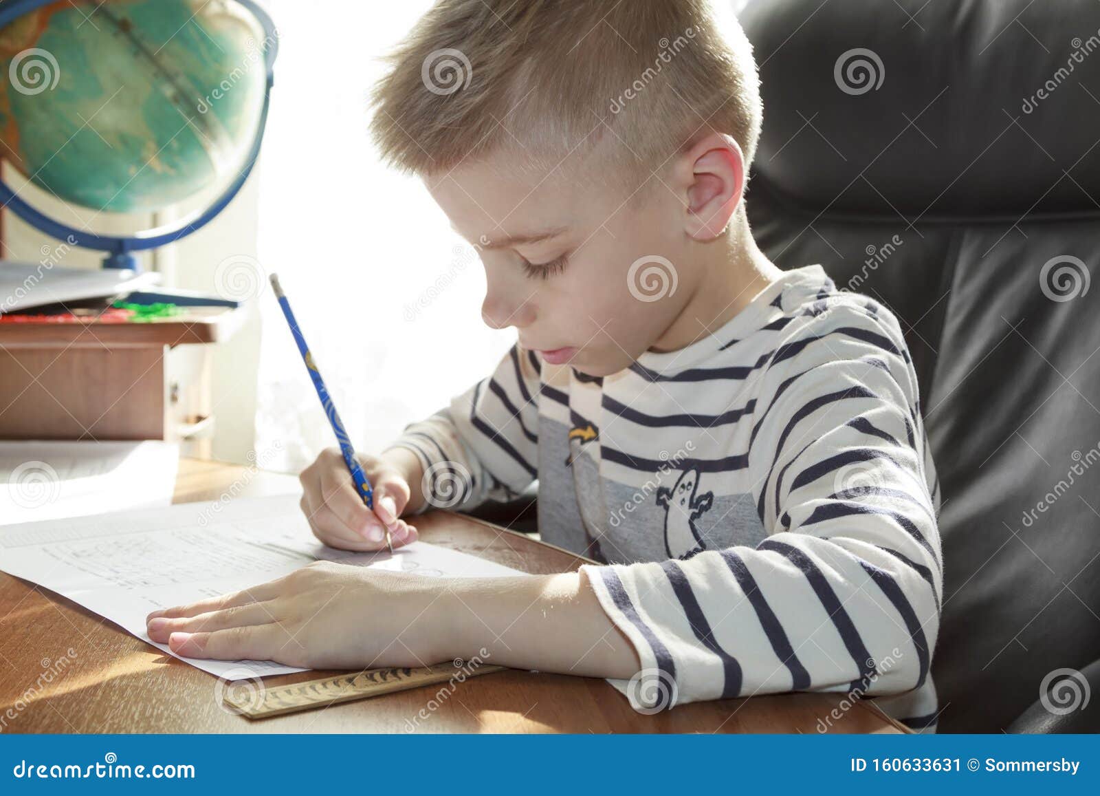 video of little boy doing math homework