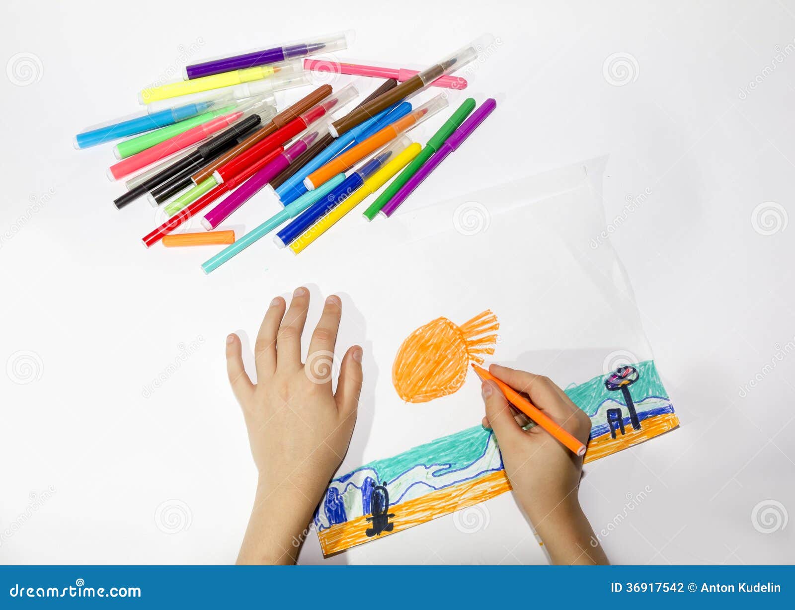 The boy draws a picture set of multicolored marker. Happy boy draws a picture set of multicolored markers